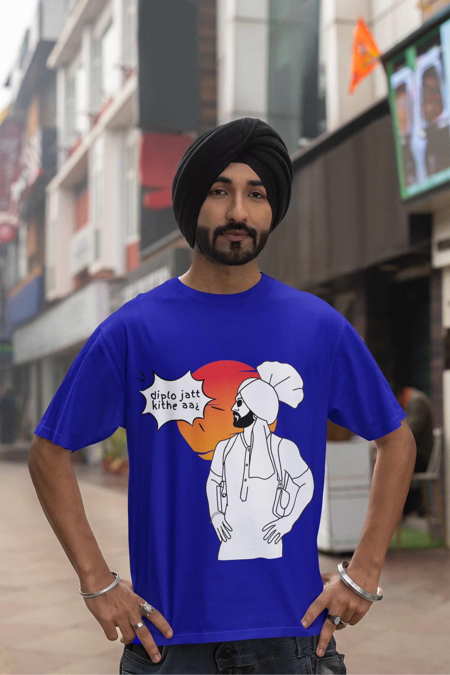 Third image of a male model wearing a royal blue oversized tshirt with a A portrait of Diljit Dosanjh wearing a stylish outfit, with the text "Diplo Jatt Kithe Aai" prominently displayed in the background. The design captures the artist's charisma and the energy of the hit song, making it a must-have for fans of Diljit Dosanjh and Diplo alike.