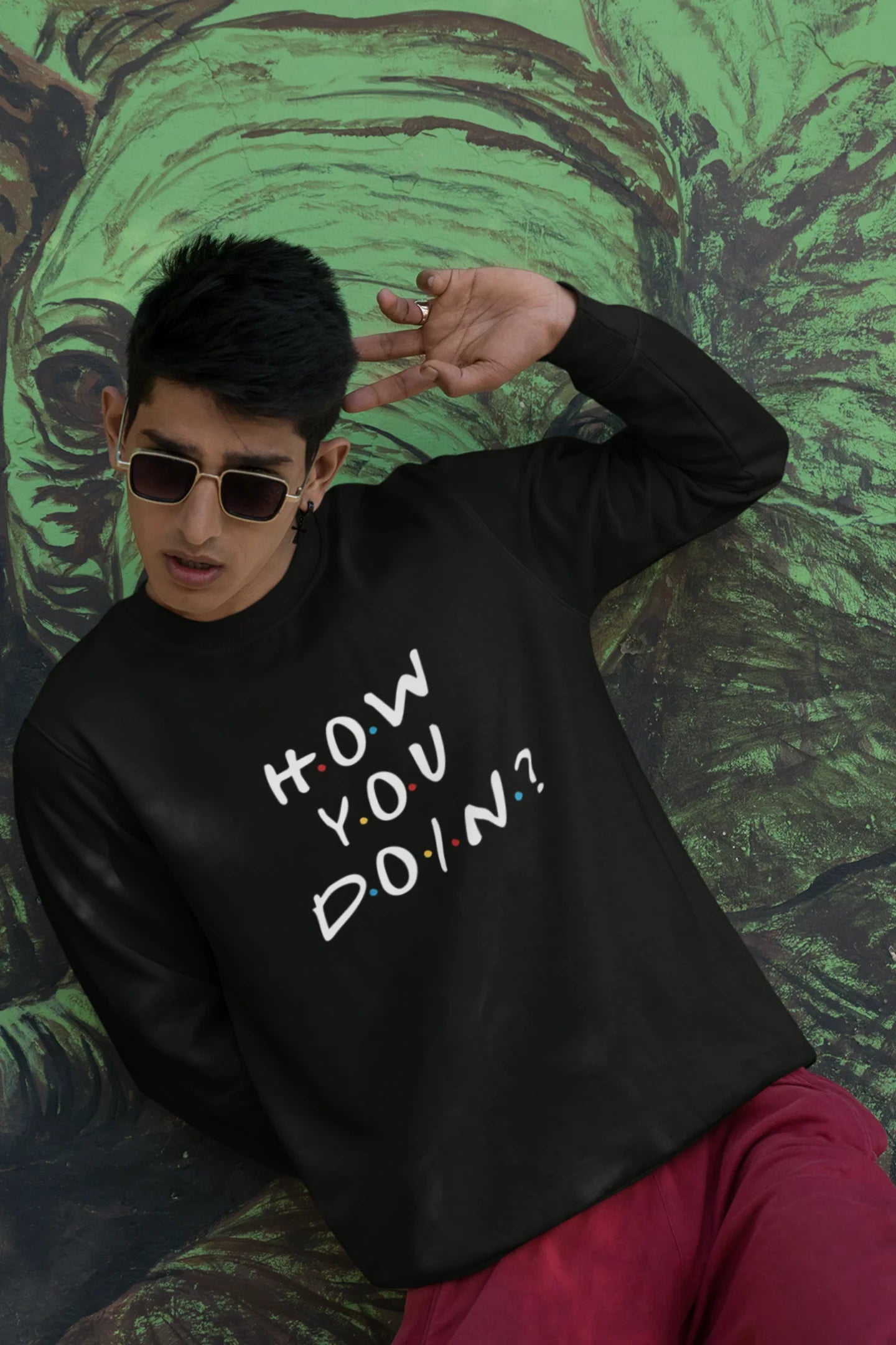 First image of male model wearing black sweatshirt with F.R.I.E.N.D.S series inspired designs, embodying Joey's famous catchphrase 'How You Doin'?