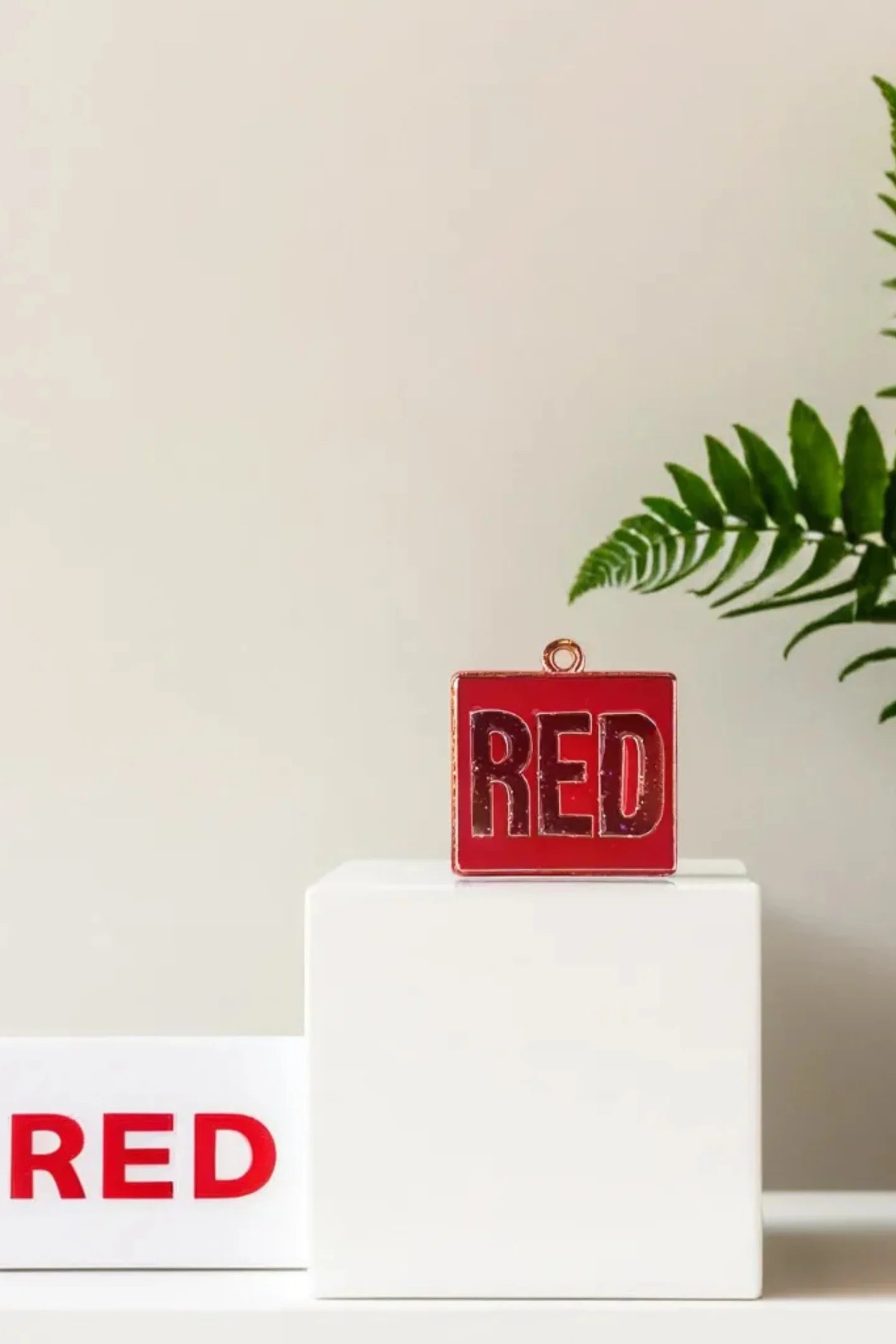 Second image of a taylor swift RED era themed charm for swifties.