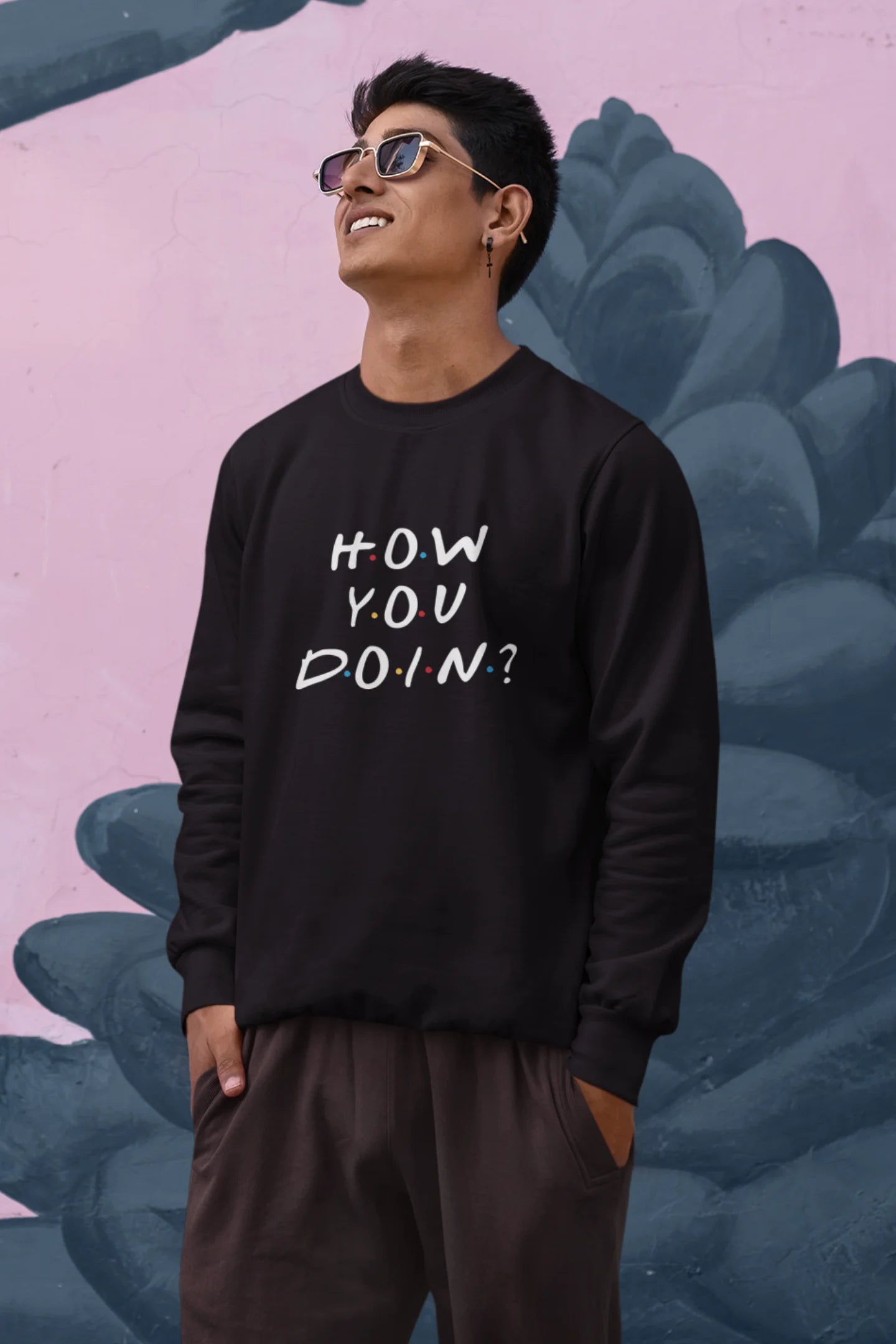 Third image of male model wearing black sweatshirt with F.R.I.E.N.D.S series inspired designs, embodying Joey's famous catchphrase 'How You Doin'?