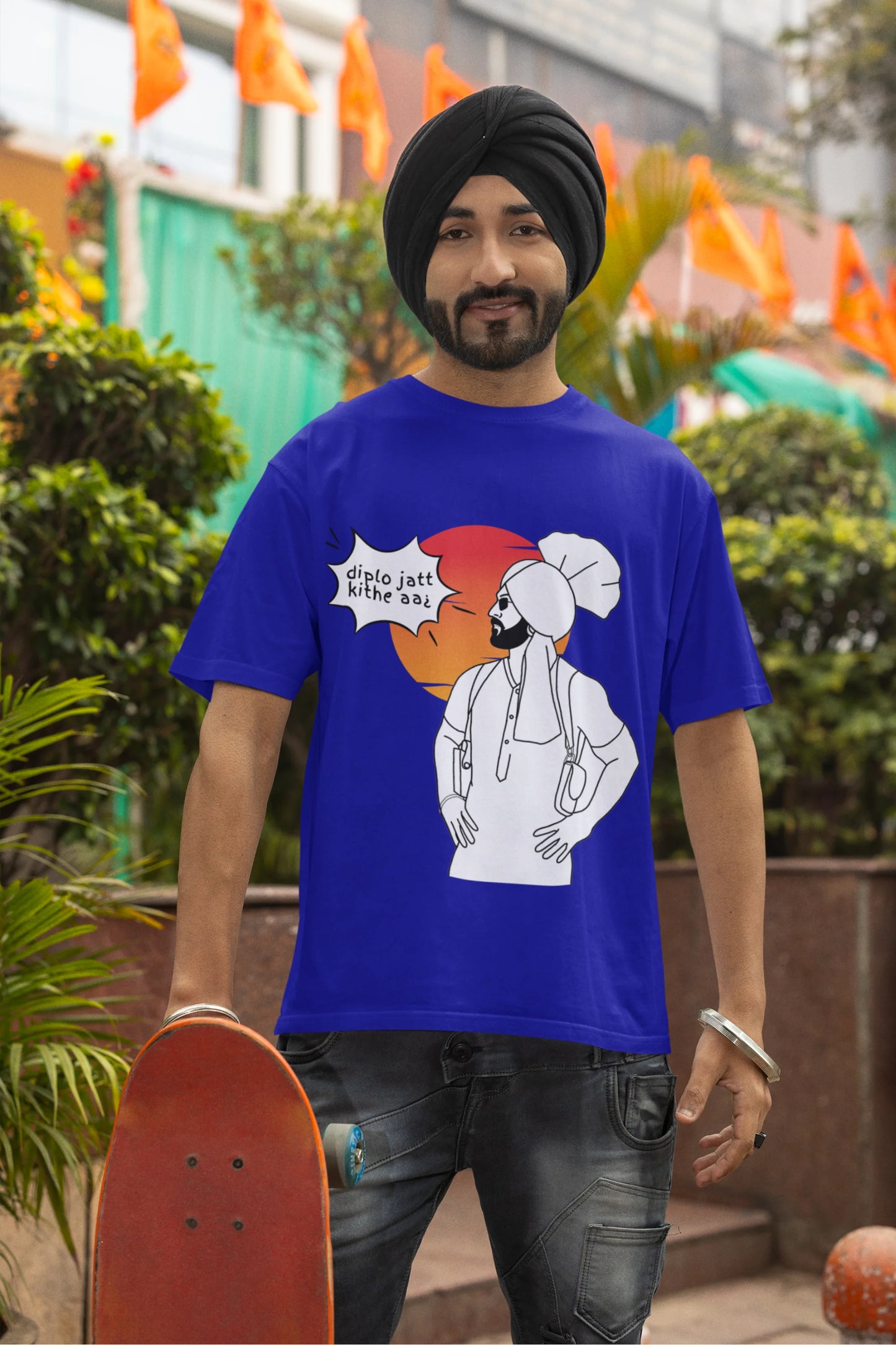 Fourth image of a male model wearing a royal blue oversized tshirt with a A portrait of Diljit Dosanjh wearing a stylish outfit, with the text "Diplo Jatt Kithe Aai" prominently displayed in the background. The design captures the artist's charisma and the energy of the hit song, making it a must-have for fans of Diljit Dosanjh and Diplo alike.