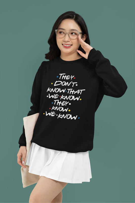 First image of female model wearing black sweatshirt with F.R.I.E.N.D.S series inspired designs, embodying Phoebe's unique humor with the quote 'They Know We Know'