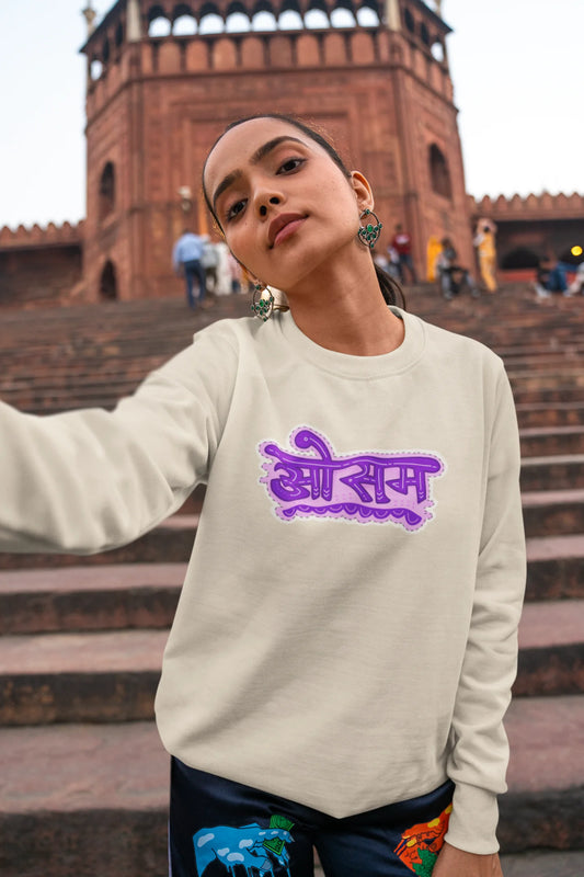 3rd front view of a female model wearing a cream colored oversized graphic t-shirt featuring the word "awesome" in a Hindi script.