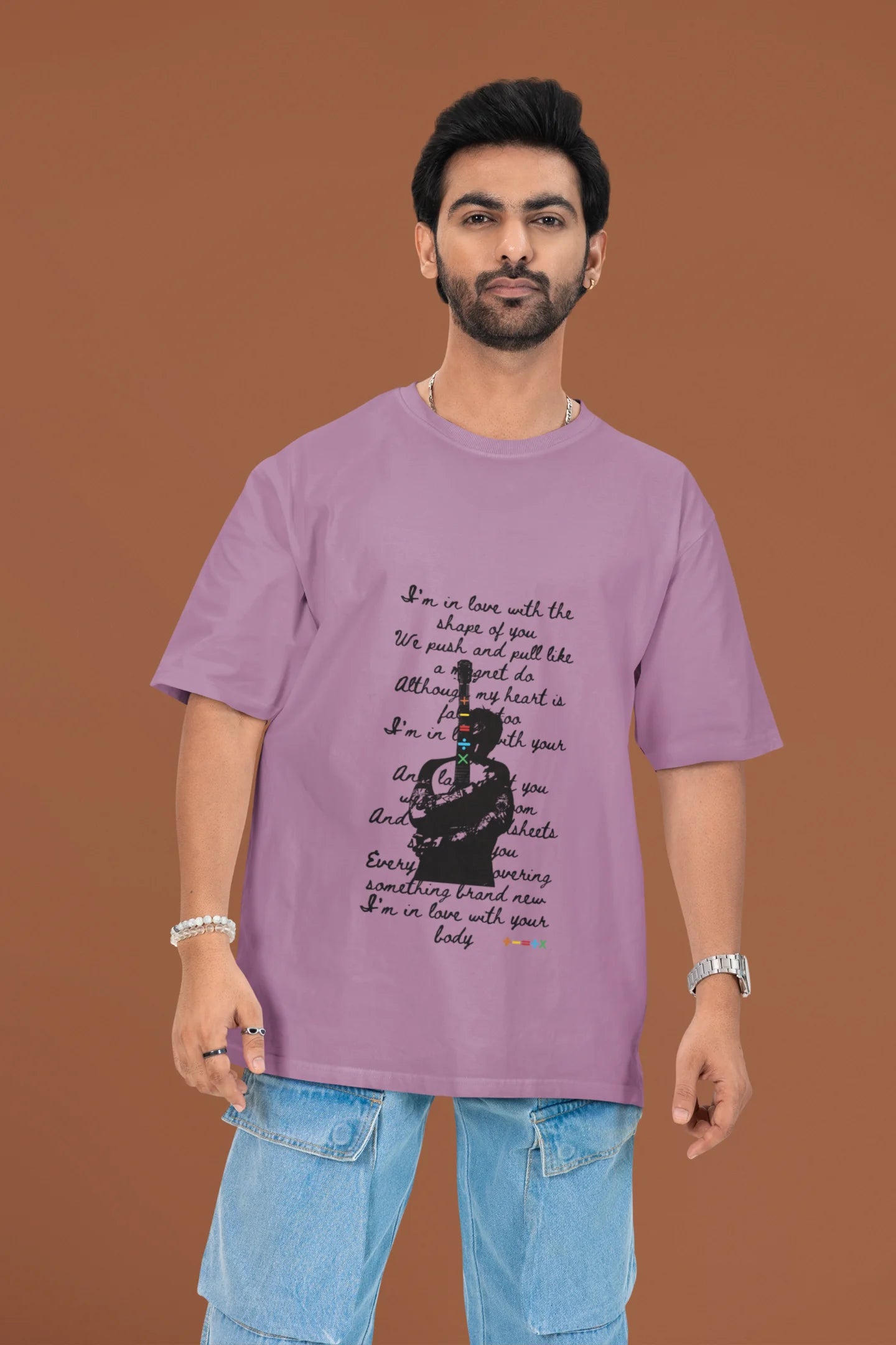 3rd front view of a male model wearing a dirty purple oversized t-shirt featuring a design inspired by Ed Sheeran's concerts, related to the song "Shape of You."