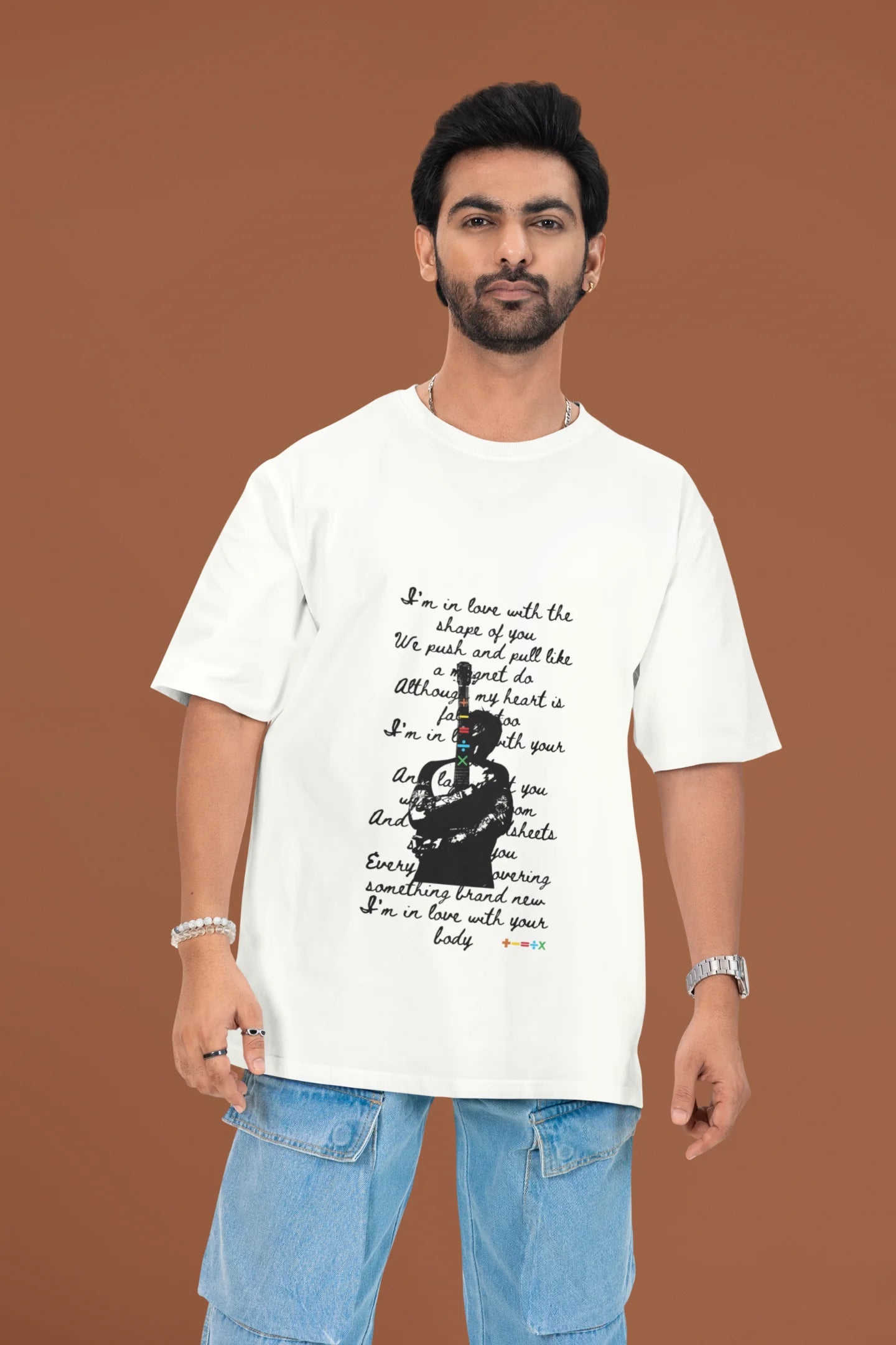 3rd front view of a male model wearing a off-white oversized t-shirt featuring a design inspired by Ed Sheeran's concerts, related to the song "Shape of You."