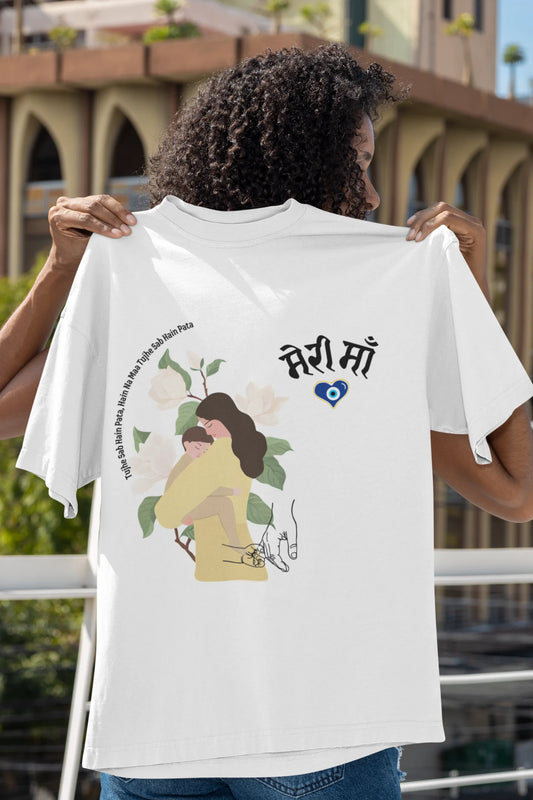 An off-white oversized t-shirt featuring a design depicting a mother tenderly holding a baby