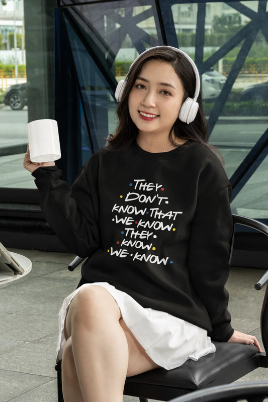 Fourth image of female model wearing black sweatshirt with F.R.I.E.N.D.S series inspired designs, embodying Phoebe's unique humor with the quote 'They Know We Know'