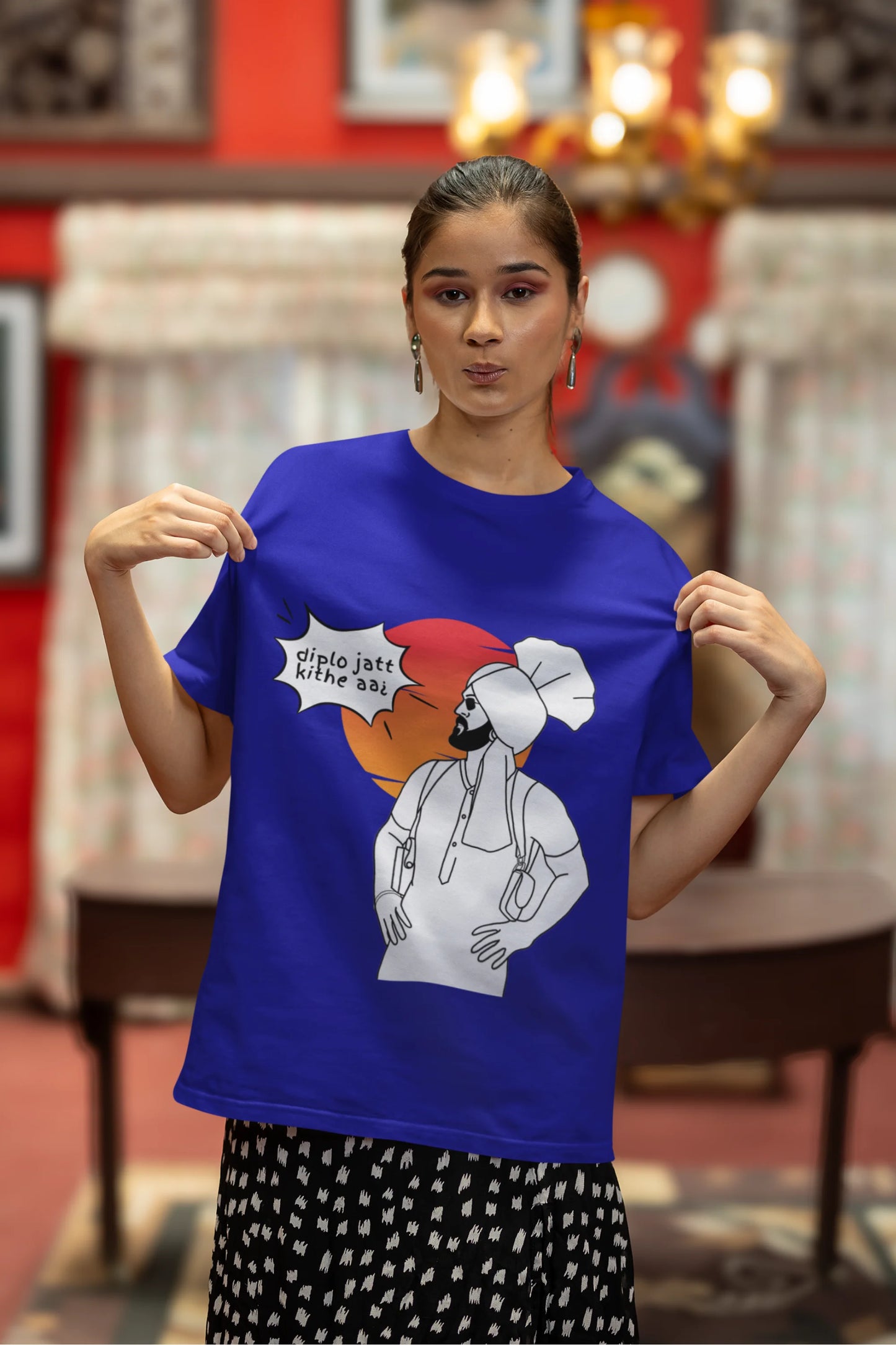 Third image of a female model wearing a royal blue oversized tshirt with a A portrait of Diljit Dosanjh wearing a stylish outfit, with the text "Diplo Jatt Kithe Aai" prominently displayed in the background. The design captures the artist's charisma and the energy of the hit song, making it a must-have for fans of Diljit Dosanjh and Diplo alike.