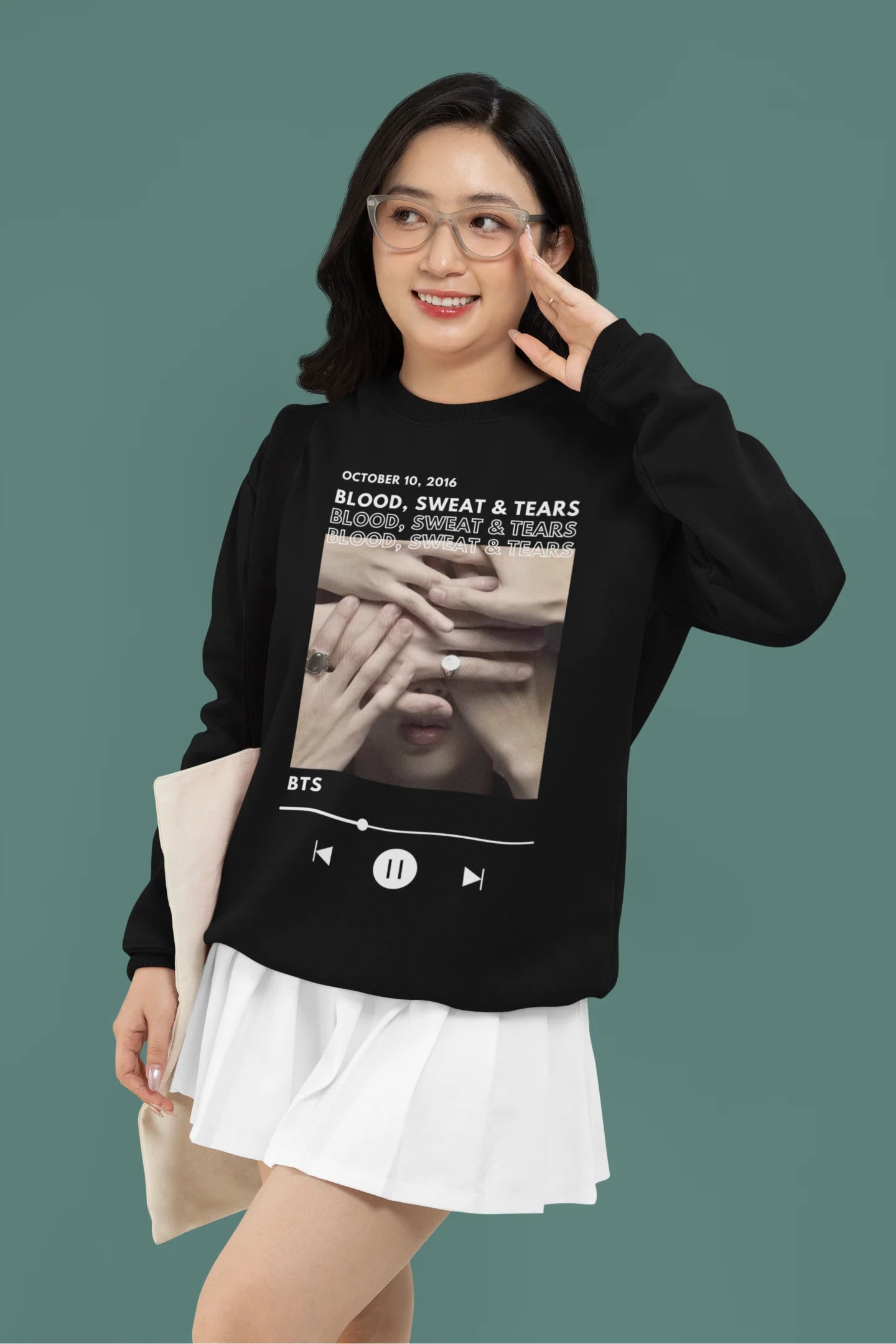 First front view of a female model wearing a black sweatshirt featuring a design inspired by BTS's music video "Blood, Sweat & Tears." Ideal for BTS fans (ARMY) who want to celebrate this iconic era.