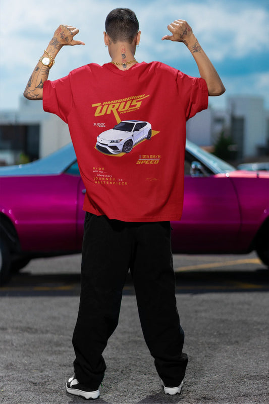 Back view of a male model wearing a red oversized t-shirt featuring a design of a Lamborghini Urus.