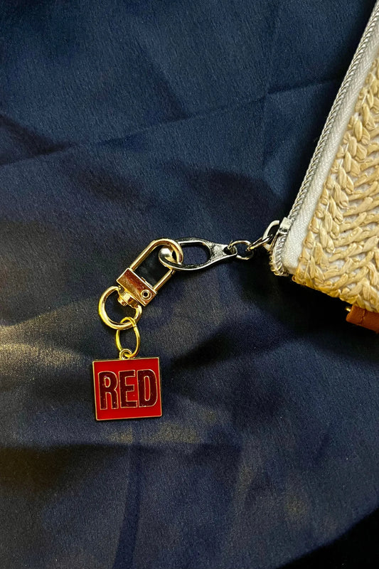 Fourth image of a taylor swift RED era themed keychain for swifties.