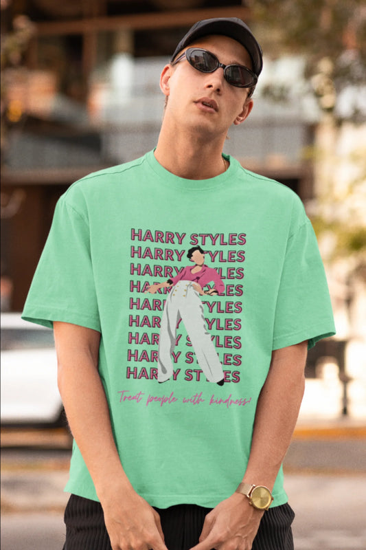 First image of male model wearing mint green oversized t-shirt inspired by Harry Styles, featuring the 'Treat People with Kindness' mantra from the Fine Line collection.