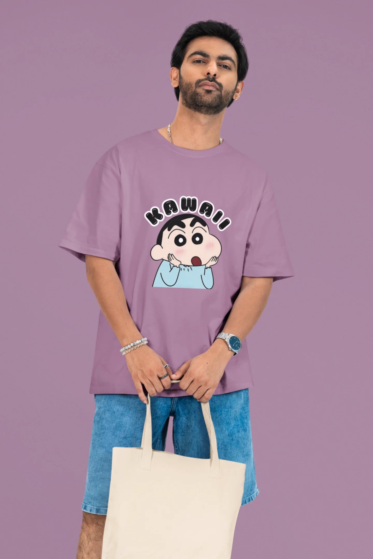 2nd front view of a male model wearin a dirty purple oversized t-shirt featuring Shinchan looking amazed and saying "Kawaii."
