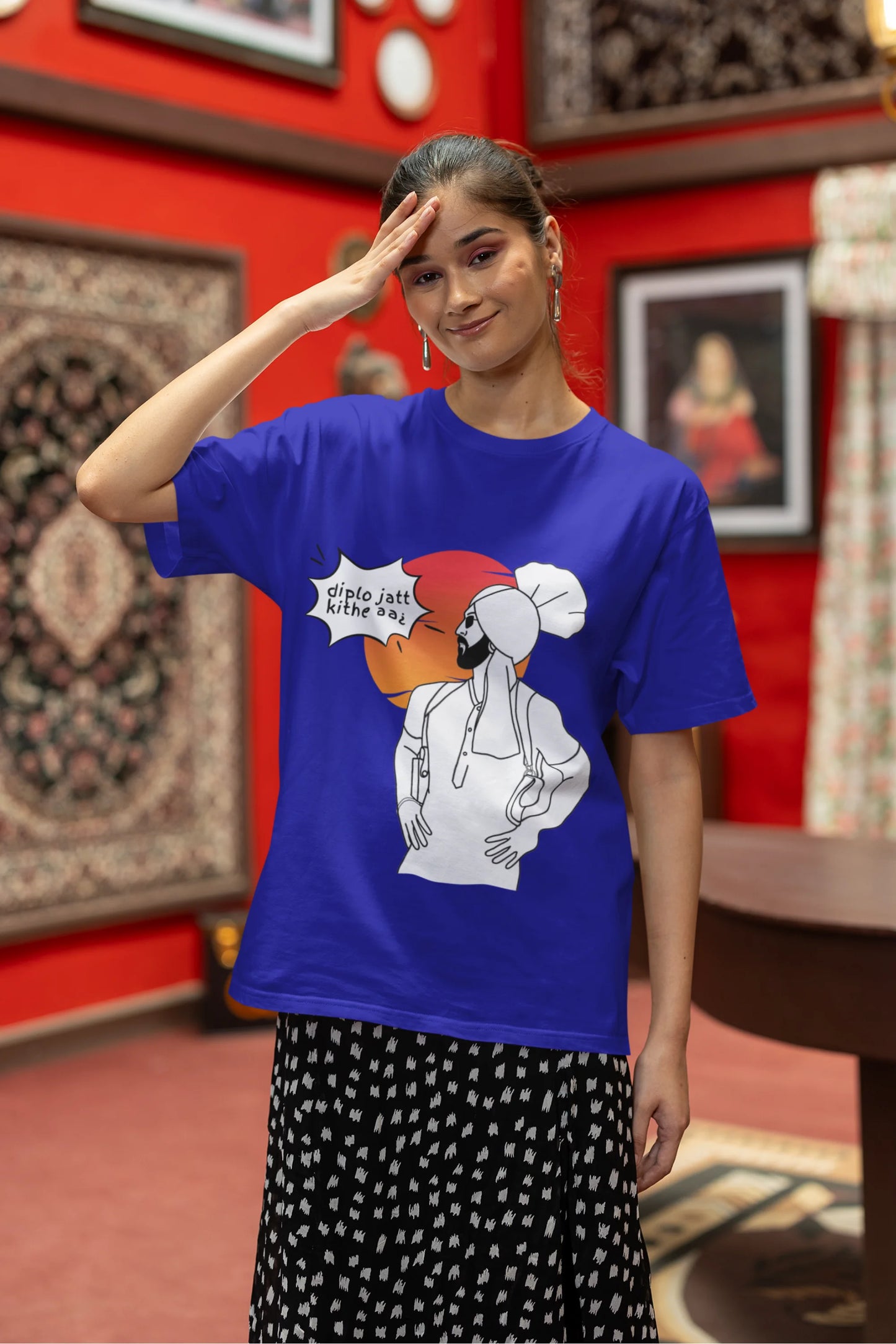 First image of a female model wearing a royal blue oversized tshirt with a A portrait of Diljit Dosanjh wearing a stylish outfit, with the text "Diplo Jatt Kithe Aai" prominently displayed in the background. The design captures the artist's charisma and the energy of the hit song, making it a must-have for fans of Diljit Dosanjh and Diplo alike.