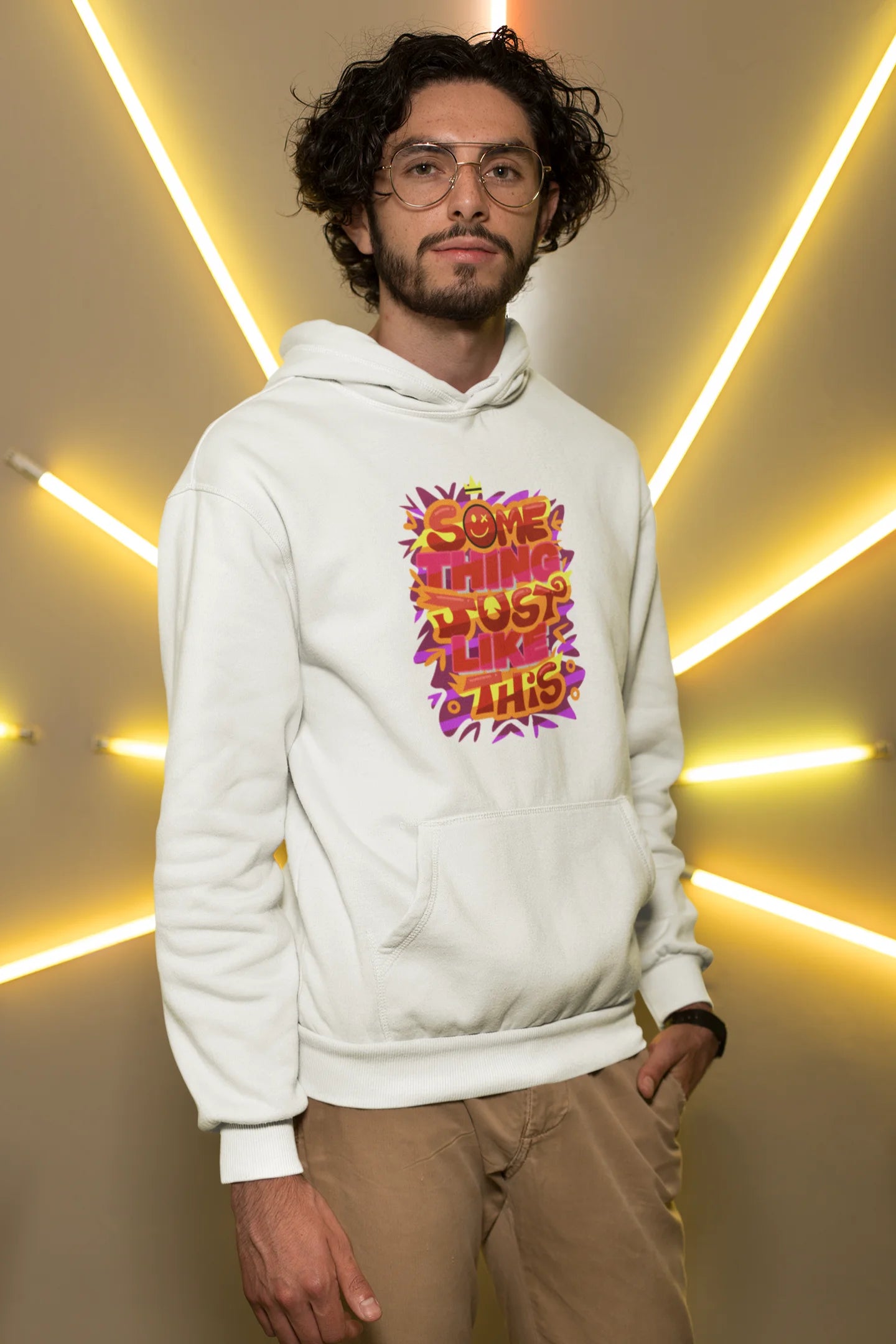 Third front view of a male model wearing an off-white hoodie featuring the designs inspired from Coldplay's "Something Just Like This" music video.