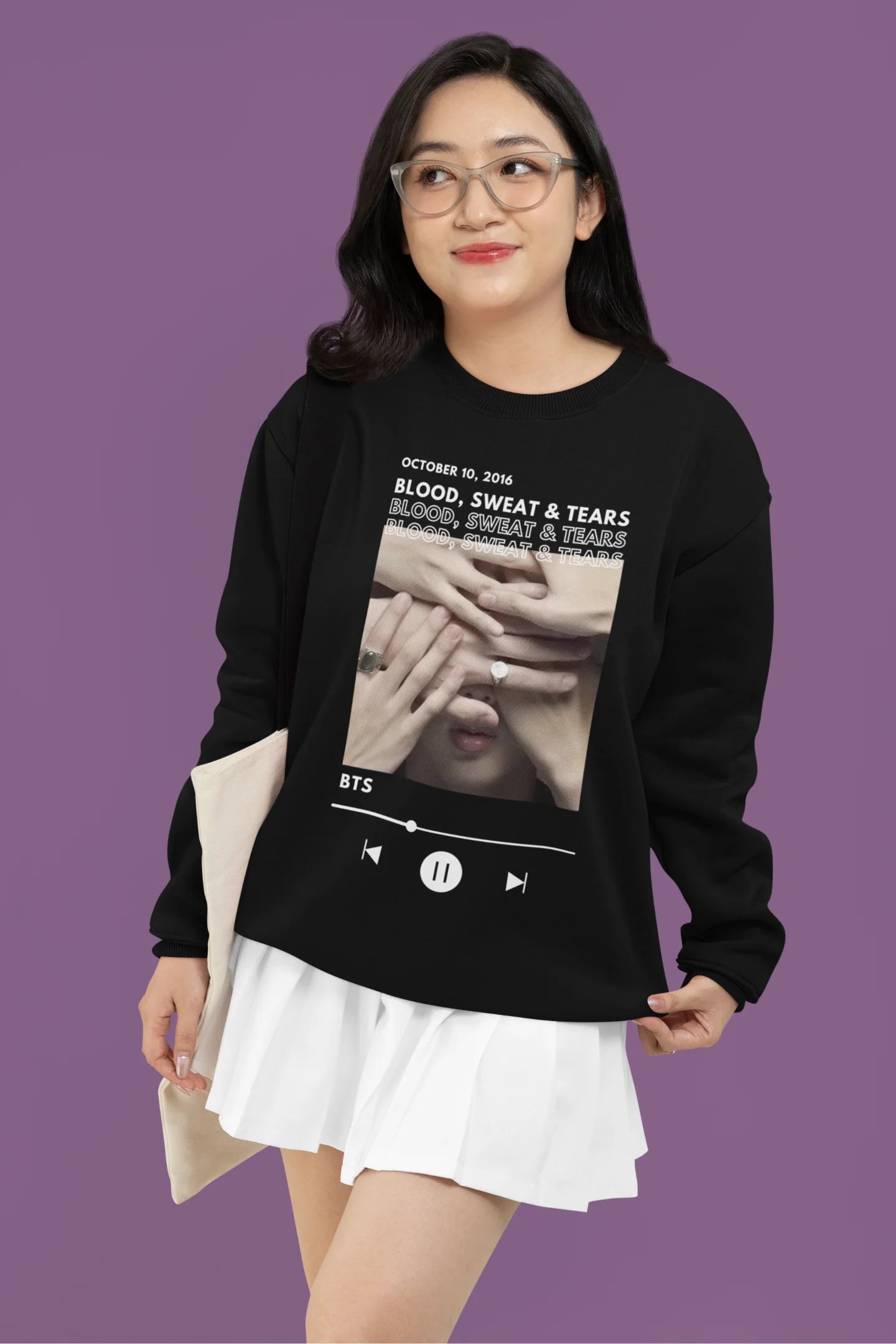 Third front view of a female model wearing a black sweatshirt featuring a design inspired by BTS's music video "Blood, Sweat & Tears." Ideal for BTS fans (ARMY) who want to celebrate this iconic era.
