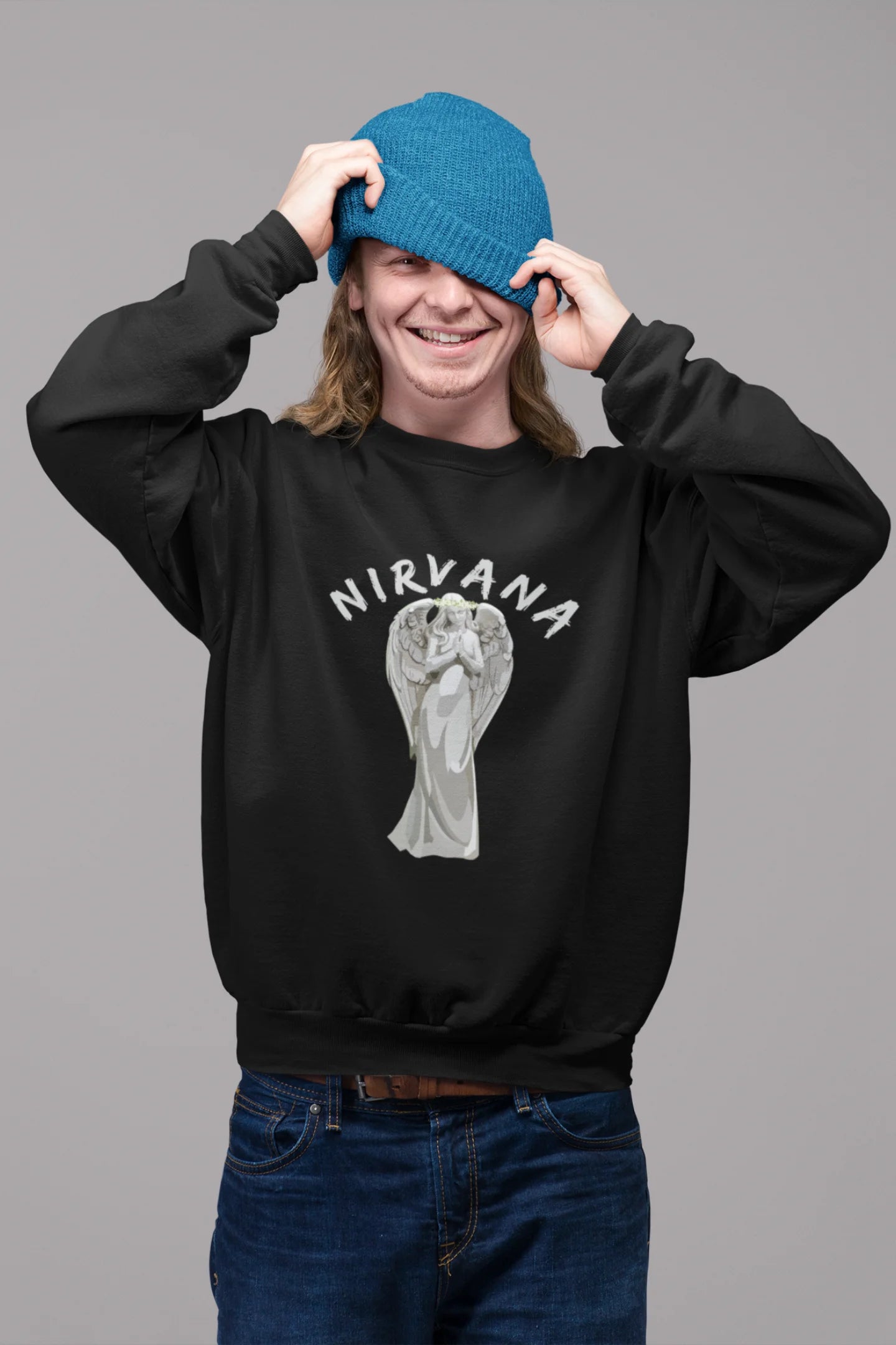 4th front image of male model wearing a black sweatshirt featuring a design of a winged angel with the text "Nirvana" above it. Ideal for fans of Nirvana and those who love grunge aesthetics.