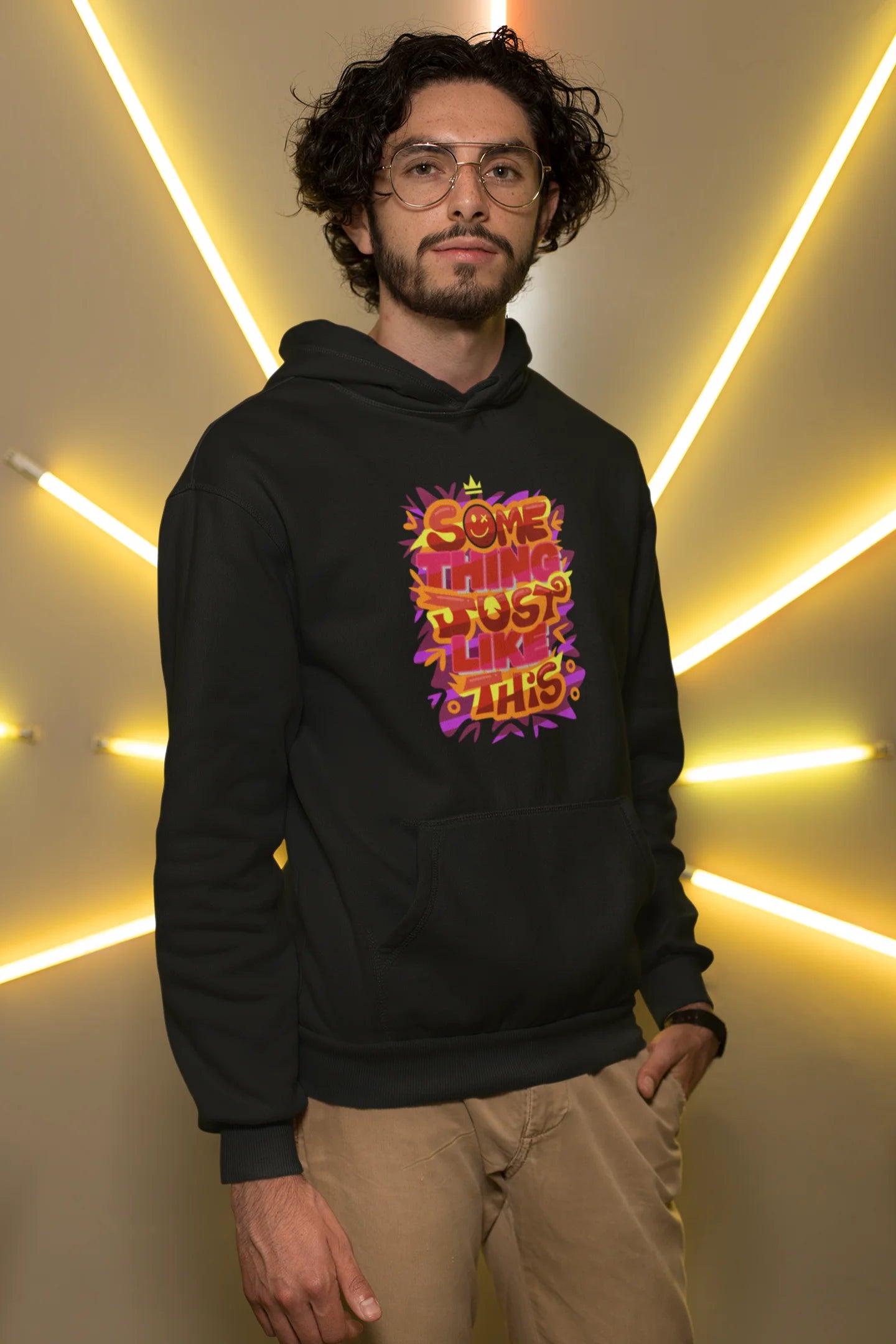 Second front view of a male model wearing an black hoodie featuring the designs inspired from Coldplay's "Something Just Like This" music video.