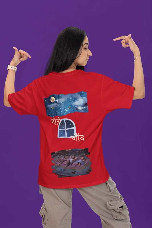 Back view of a female model wearing a red oversized t-shirt featuring an illustration called Mithi Neend of children lying or sitting on a rooftop, looking up at a starry night sky.