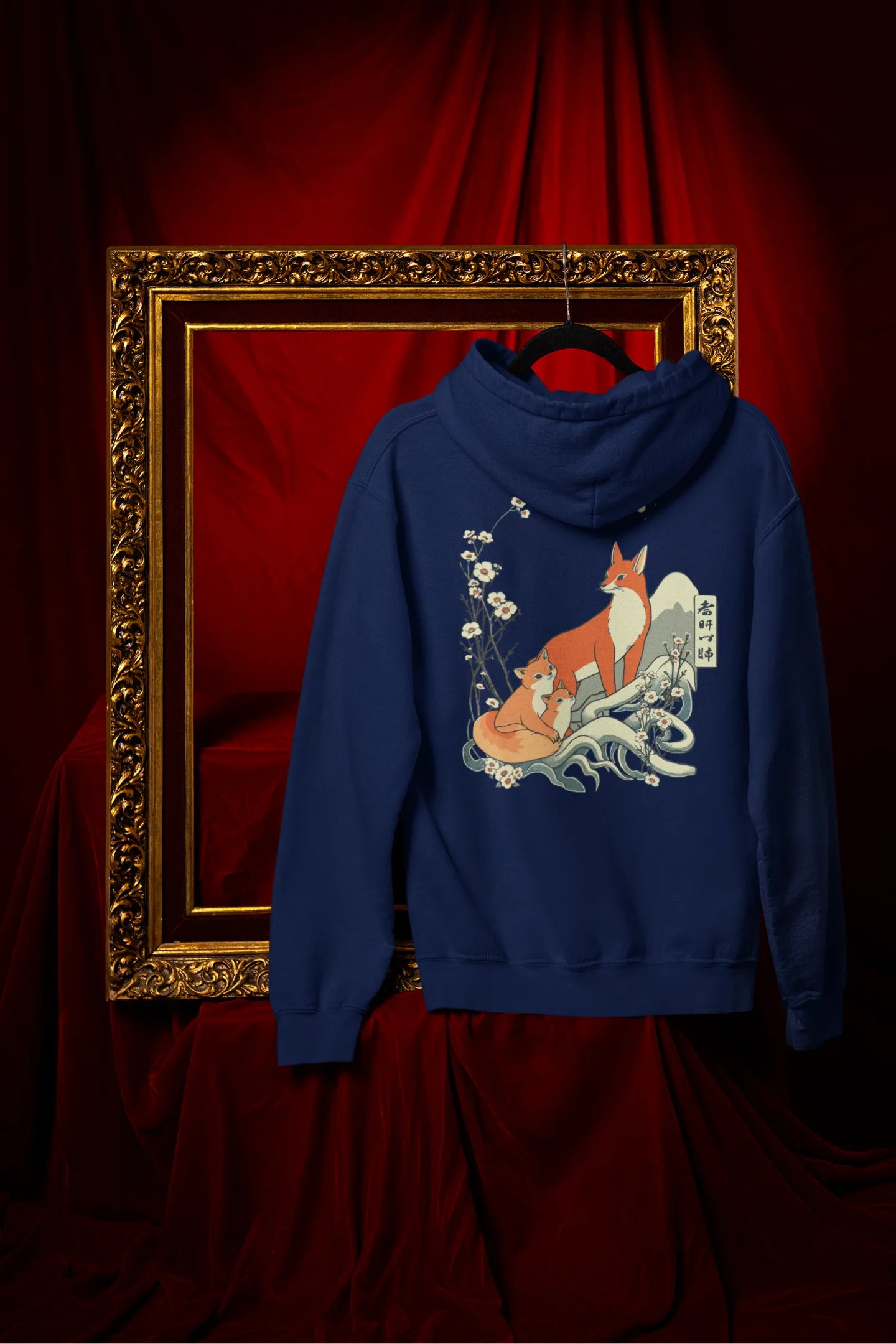 Back view of a navy blue hoodie with a design of a fox and its cub in a traditional Japanese landscape.