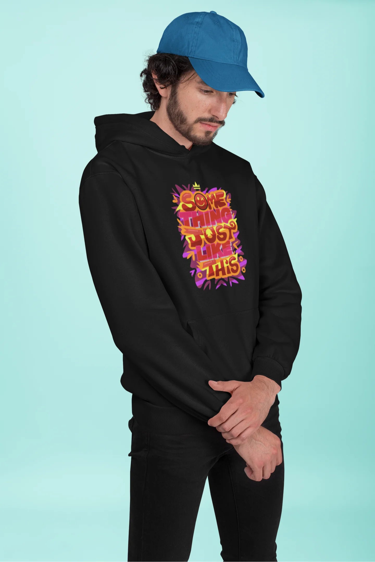 First front view of a male model wearing an black hoodie featuring the designs inspired from Coldplay's "Something Just Like This" music video.