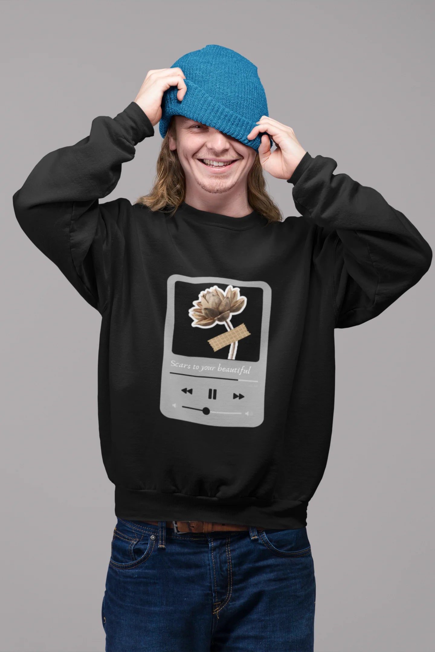 2nd front view of a male model wearing a black sweatshirt featuring a design inspired by Alessia Cara's song "Scars to Your Beautiful." The design includes flowers and a message of self-love. Ideal for fans of Alessia Cara and those who appreciate messages of empowerment.