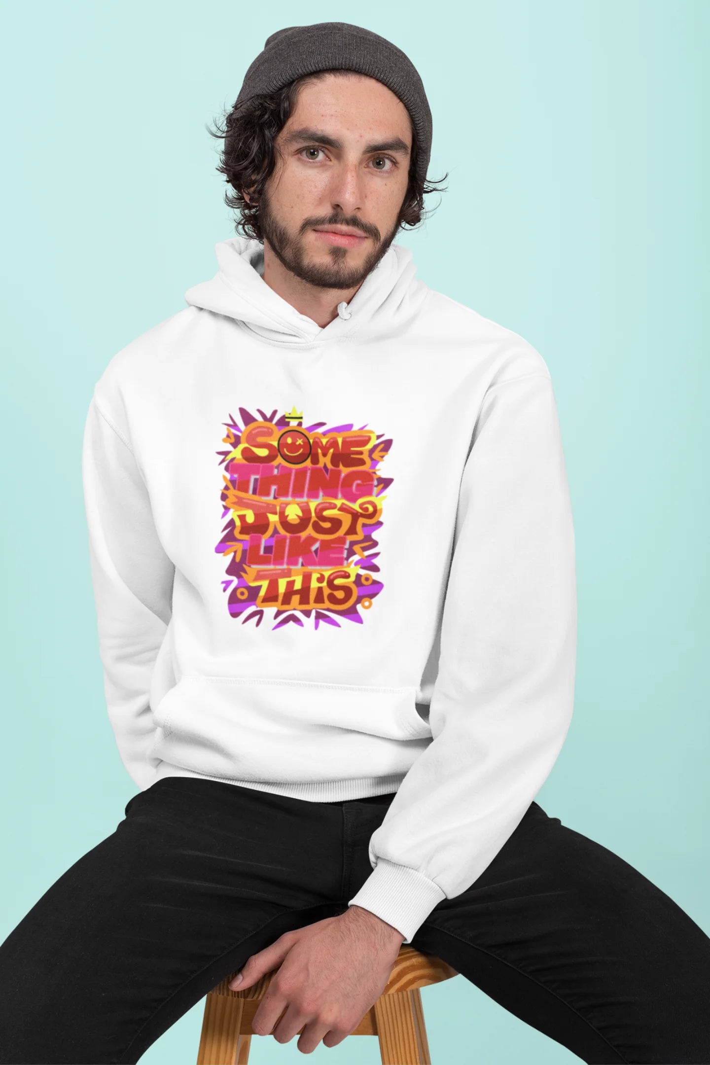 First front view of a male model wearing an off-white hoodie featuring the designs inspired from Coldplay's "Something Just Like This" music video.