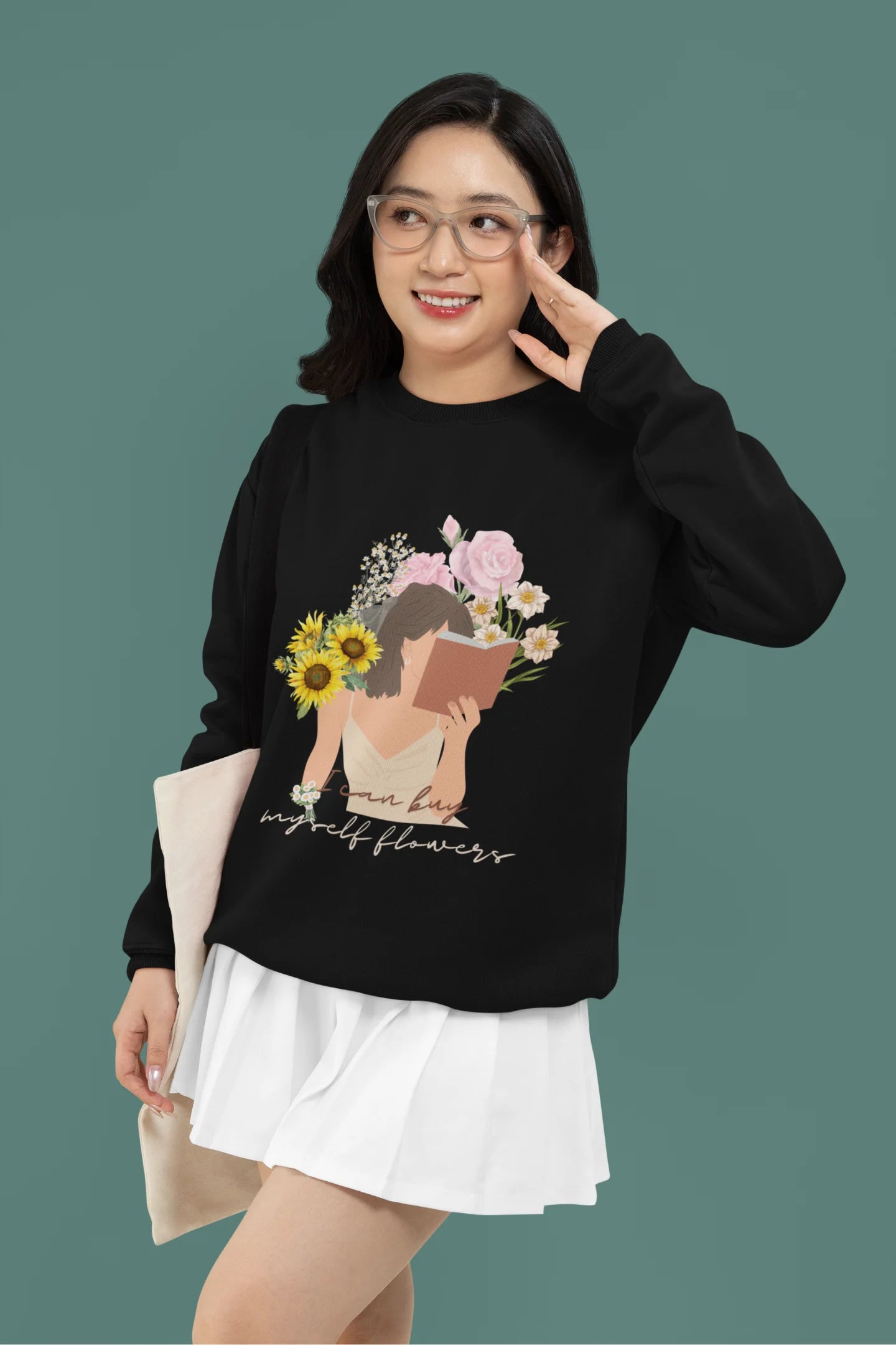 4th front view of female model wearing a black sweatshirt with a positive message "Buy Myself Flowers" and a graphic of a smiling woman surrounded by tulips and sunflowers. Ideal for those who love inspirational clothing and floral designs.