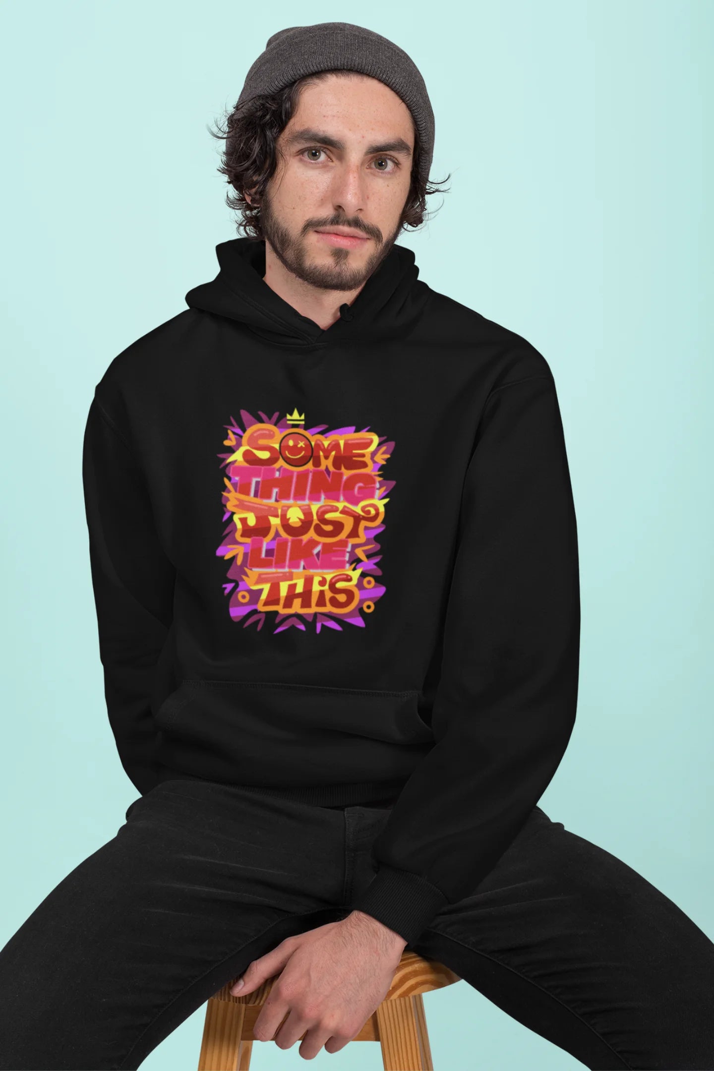 Third front view of a male model wearing an black hoodie featuring the designs inspired from Coldplay's "Something Just Like This" music video.