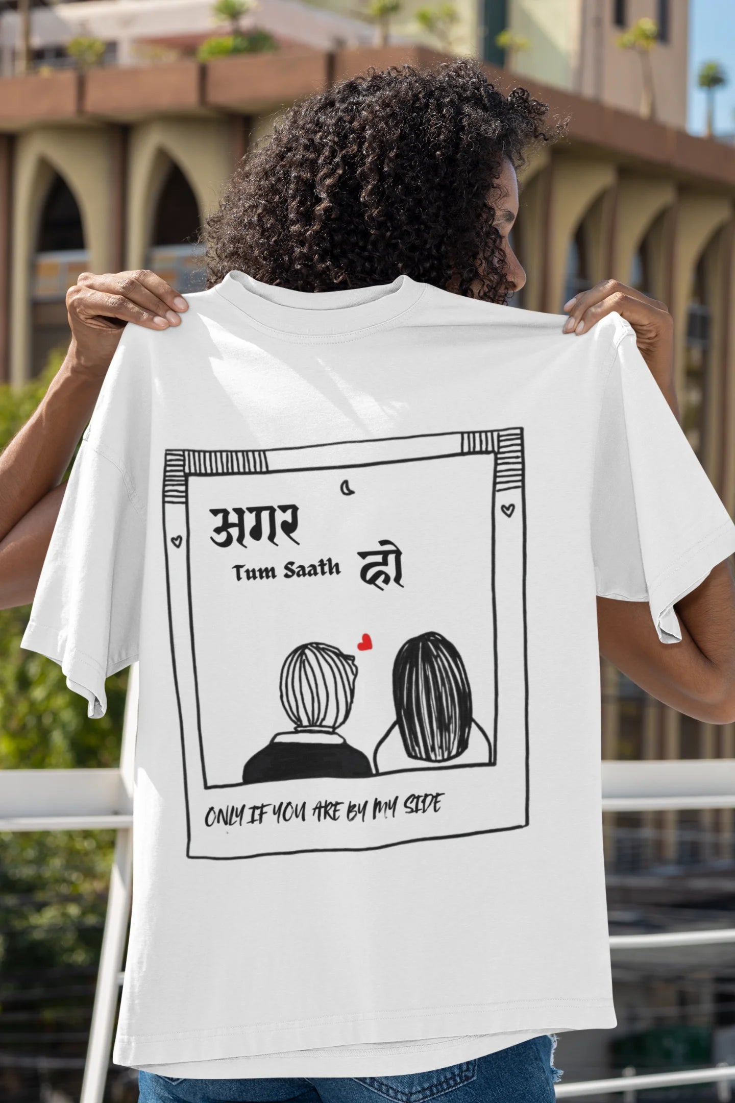 Back view of a female model wearing an off white oversized t-shirt featuring a design depicting a couple, symbolizing togetherness and romance, inspired by the Hindi film "Agar Tum Saath Ho."