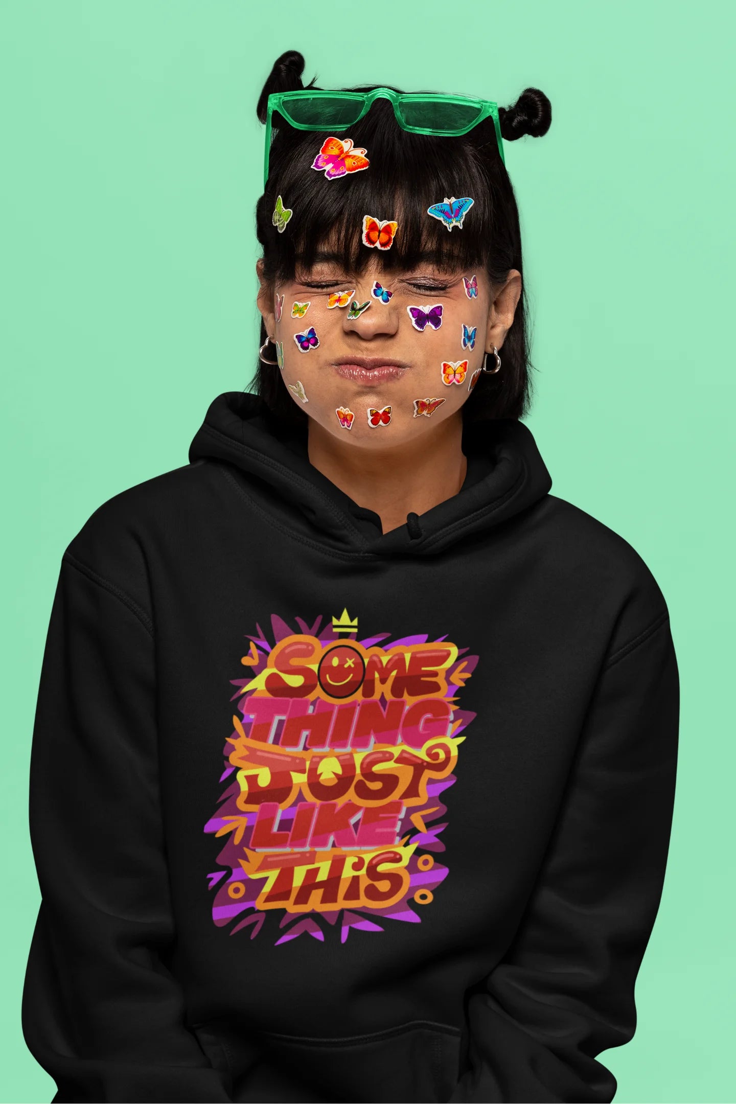 Sixth front view of a female model wearing an black hoodie featuring the designs inspired from Coldplay's "Something Just Like This" music video.