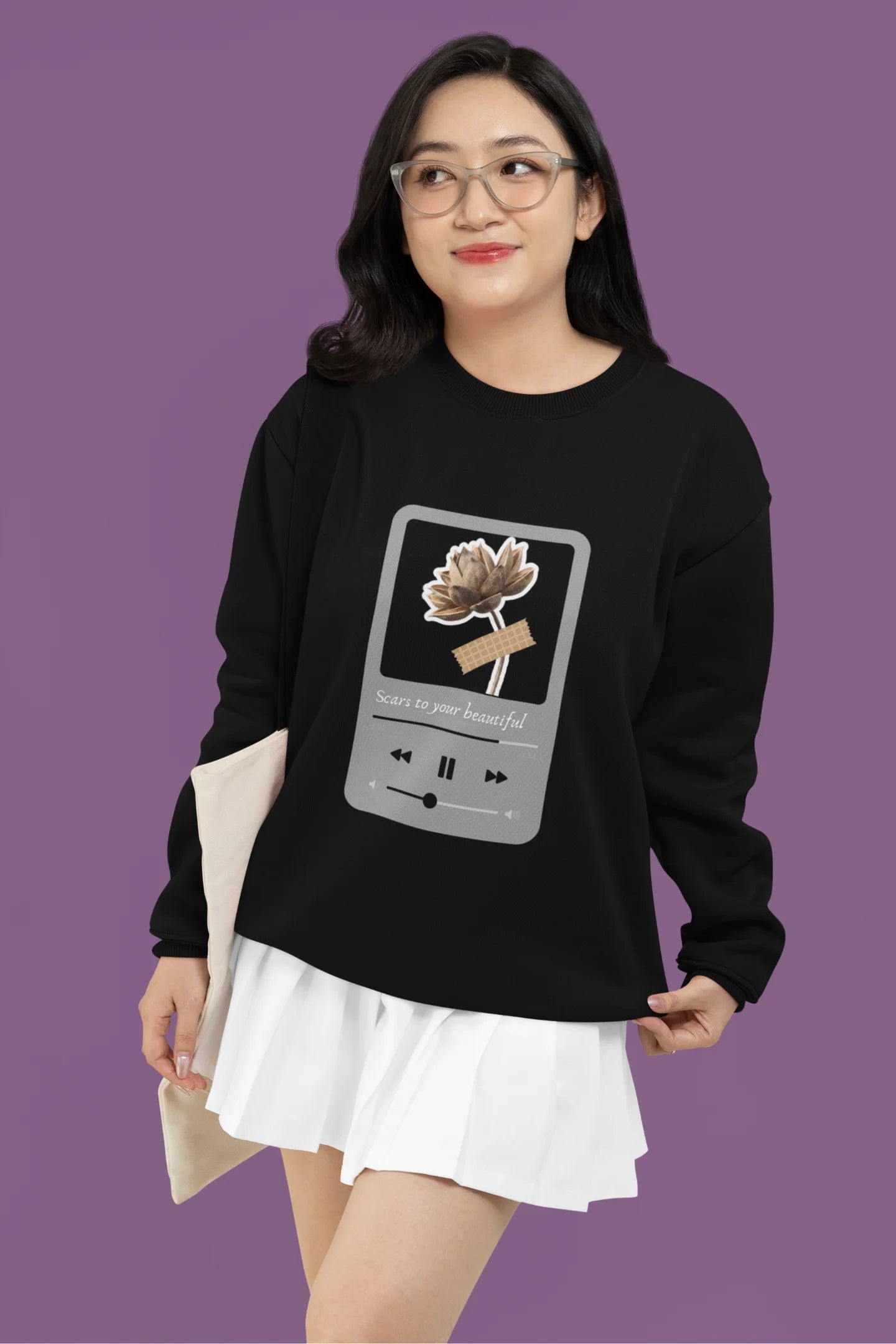 First front view of a female model wearing a black sweatshirt featuring a design inspired by Alessia Cara's song "Scars to Your Beautiful." The design includes flowers and a message of self-love. Ideal for fans of Alessia Cara and those who appreciate messages of empowerment.
