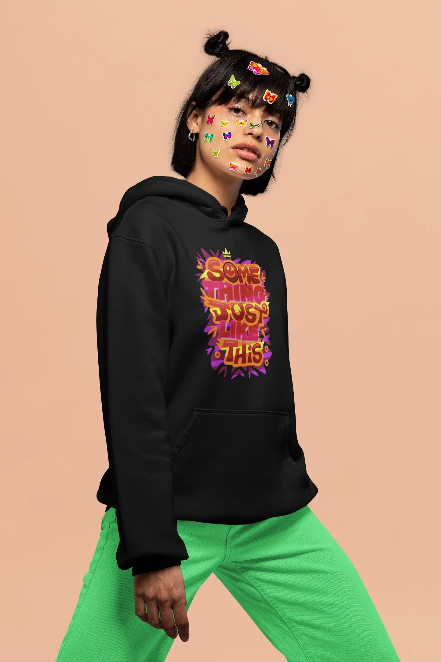 Fourth front view of a female model wearing an black hoodie featuring the designs inspired from Coldplay's "Something Just Like This" music video.