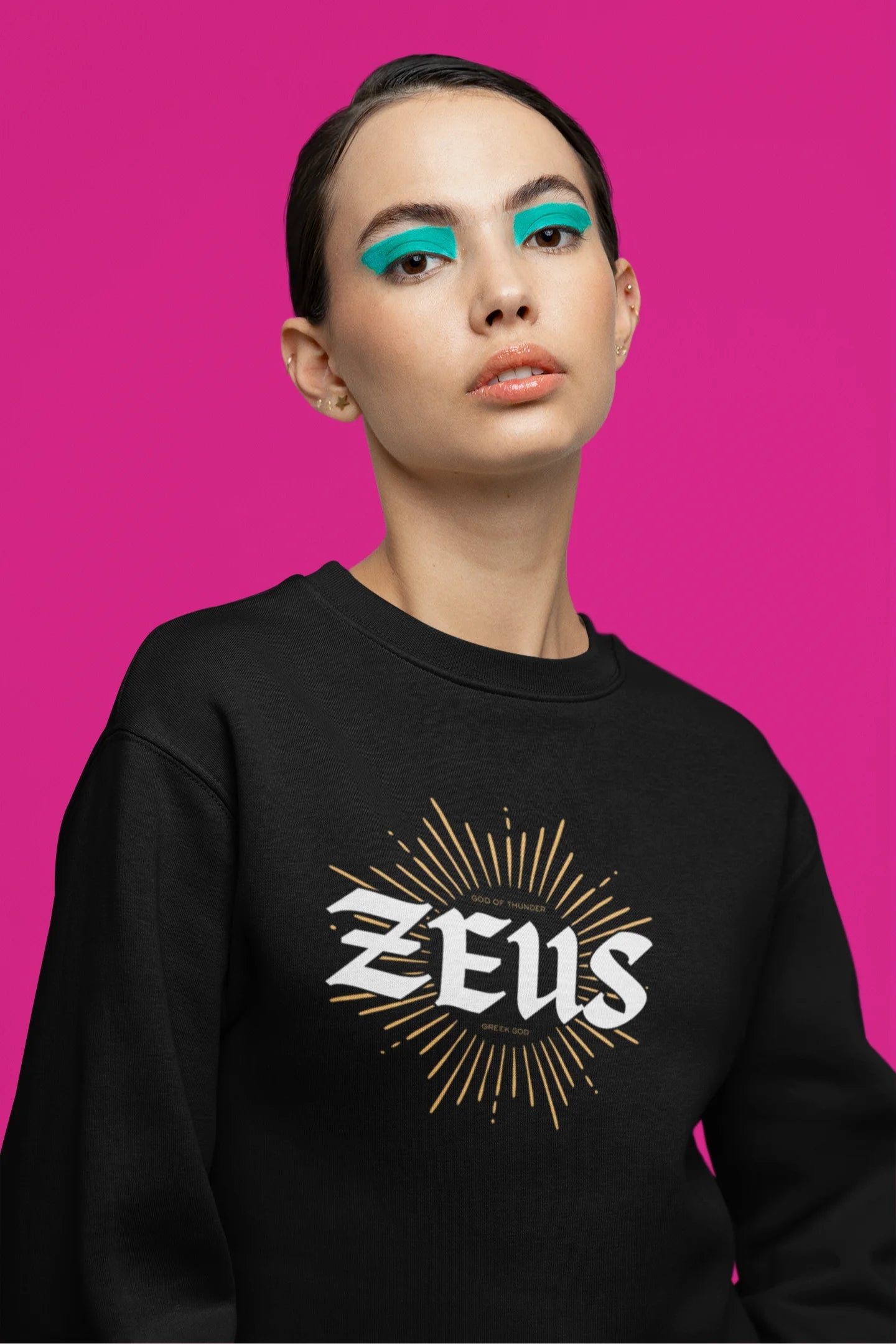Third front view of a female model wearing a brutalist-inspired black sweatshirt with a stylized image of Zeus, king of the gods, in a concrete-like design.