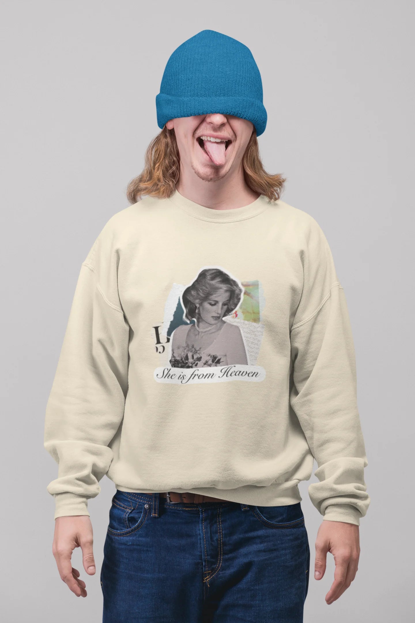 3rd front view of male model wearing a cream sweatshirt featuring a black and white photo of Princess Diana with the text "She is from Heaven." Ideal for fans of Princess Diana and those who want to celebrate a royal icon.