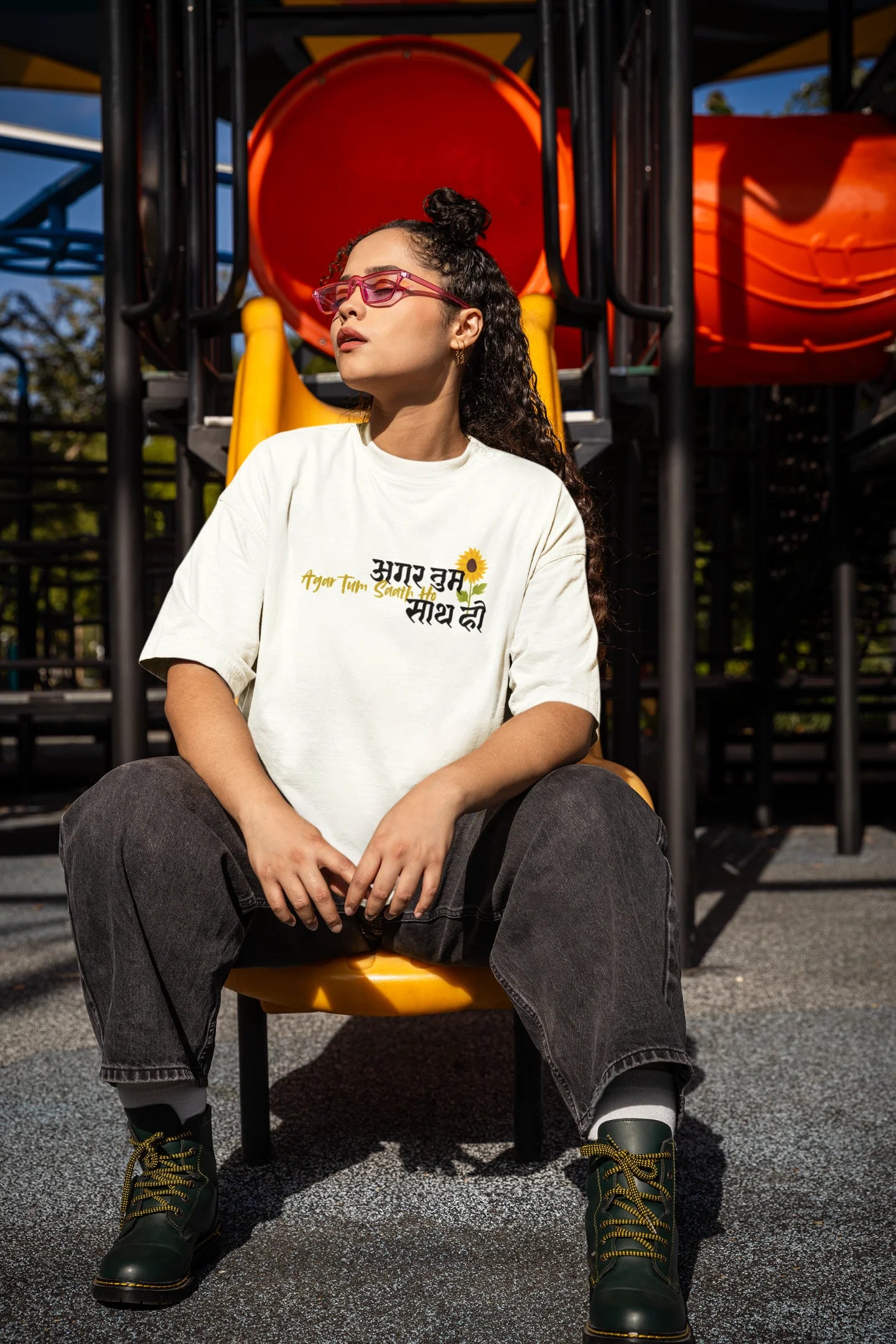 Side view of a female model wearing an off white oversized t-shirt featuring a design depicting a couple, symbolizing togetherness and romance, inspired by the Hindi film "Agar Tum Saath Ho."