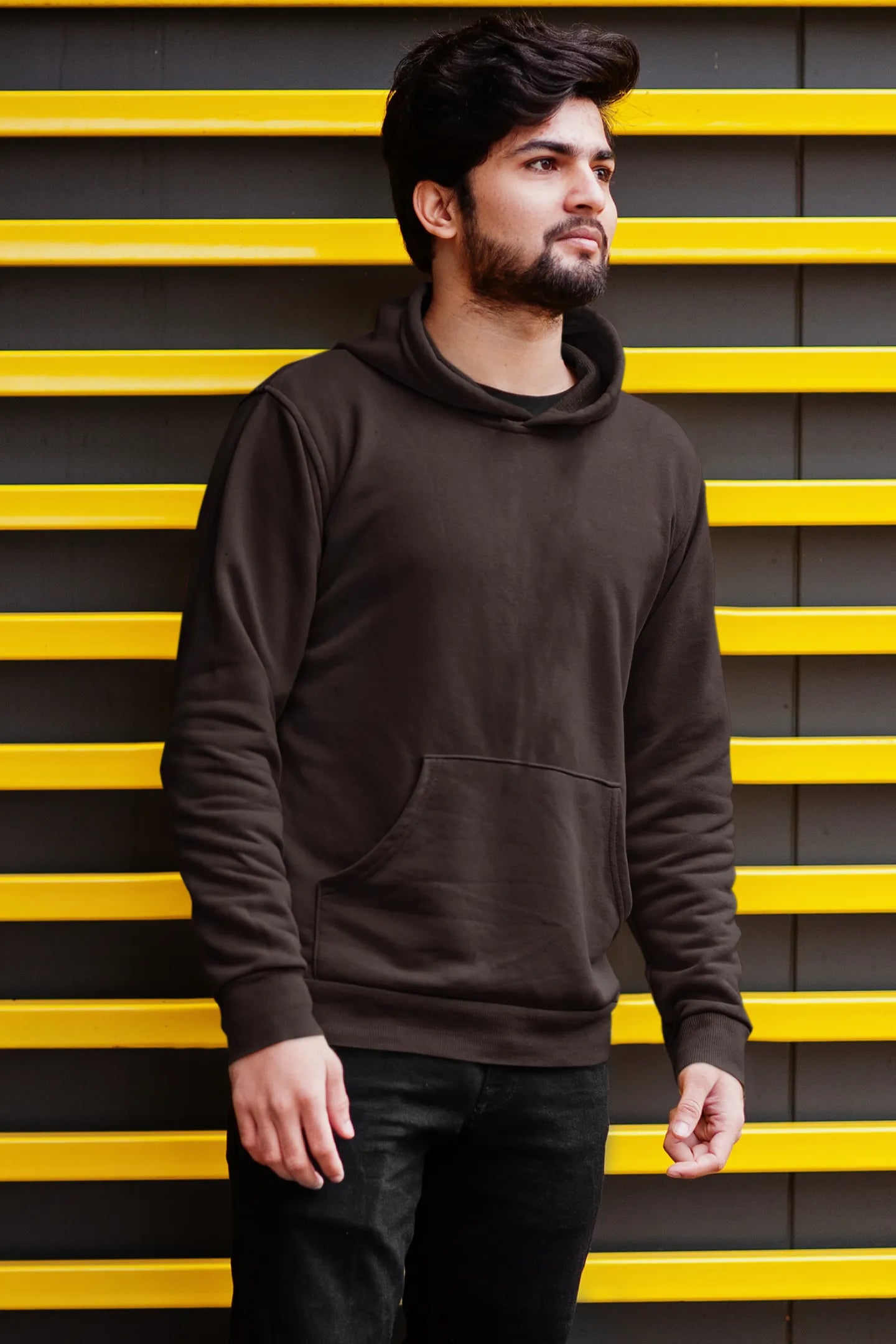 Third front view male model wearing a chocolate brown hoodie with a design of a fox and its cub in a traditional Japanese landscape.