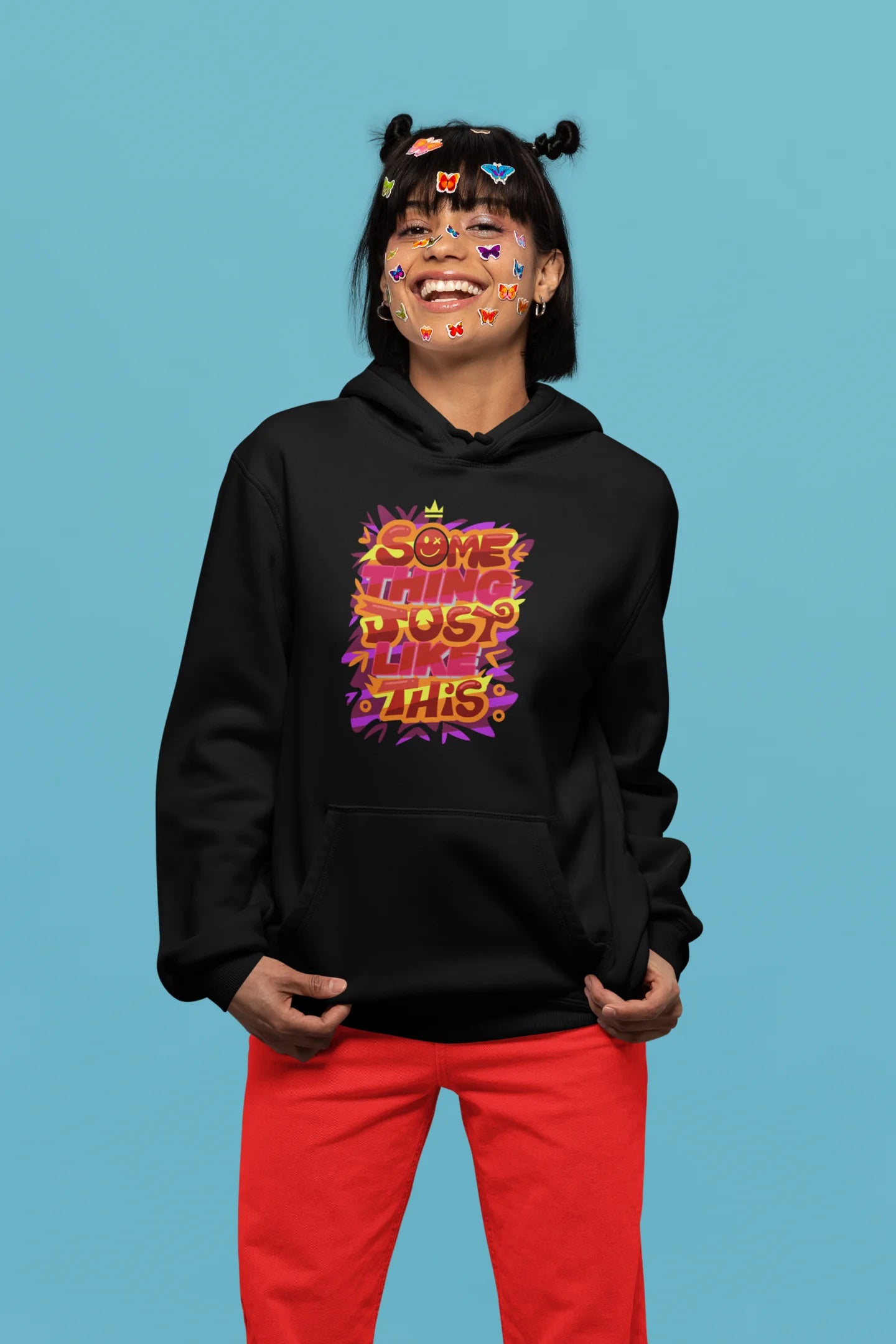 Third front view of a female model wearing an black hoodie featuring the designs inspired from Coldplay's "Something Just Like This" music video.