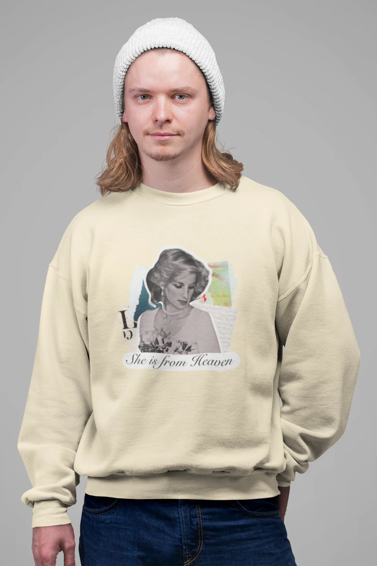 2nd front view of male model wearing a cream sweatshirt featuring a black and white photo of Princess Diana with the text "She is from Heaven." Ideal for fans of Princess Diana and those who want to celebrate a royal icon.