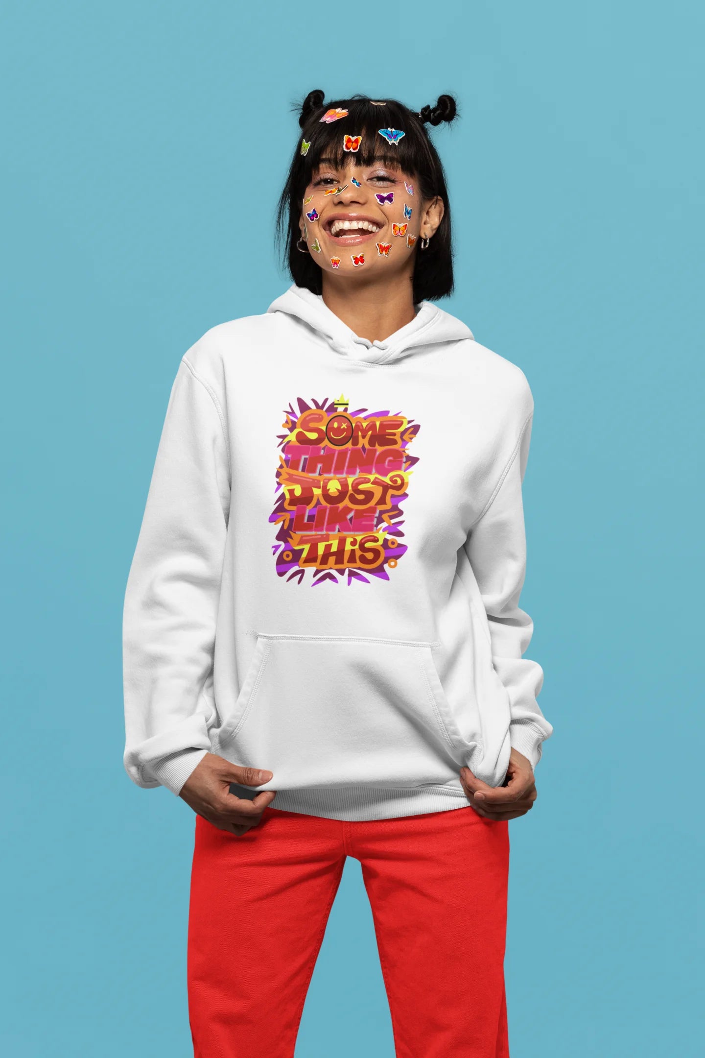 Fifth front view of a female model wearing an off-white hoodie featuring the designs inspired from Coldplay's "Something Just Like This" music video.