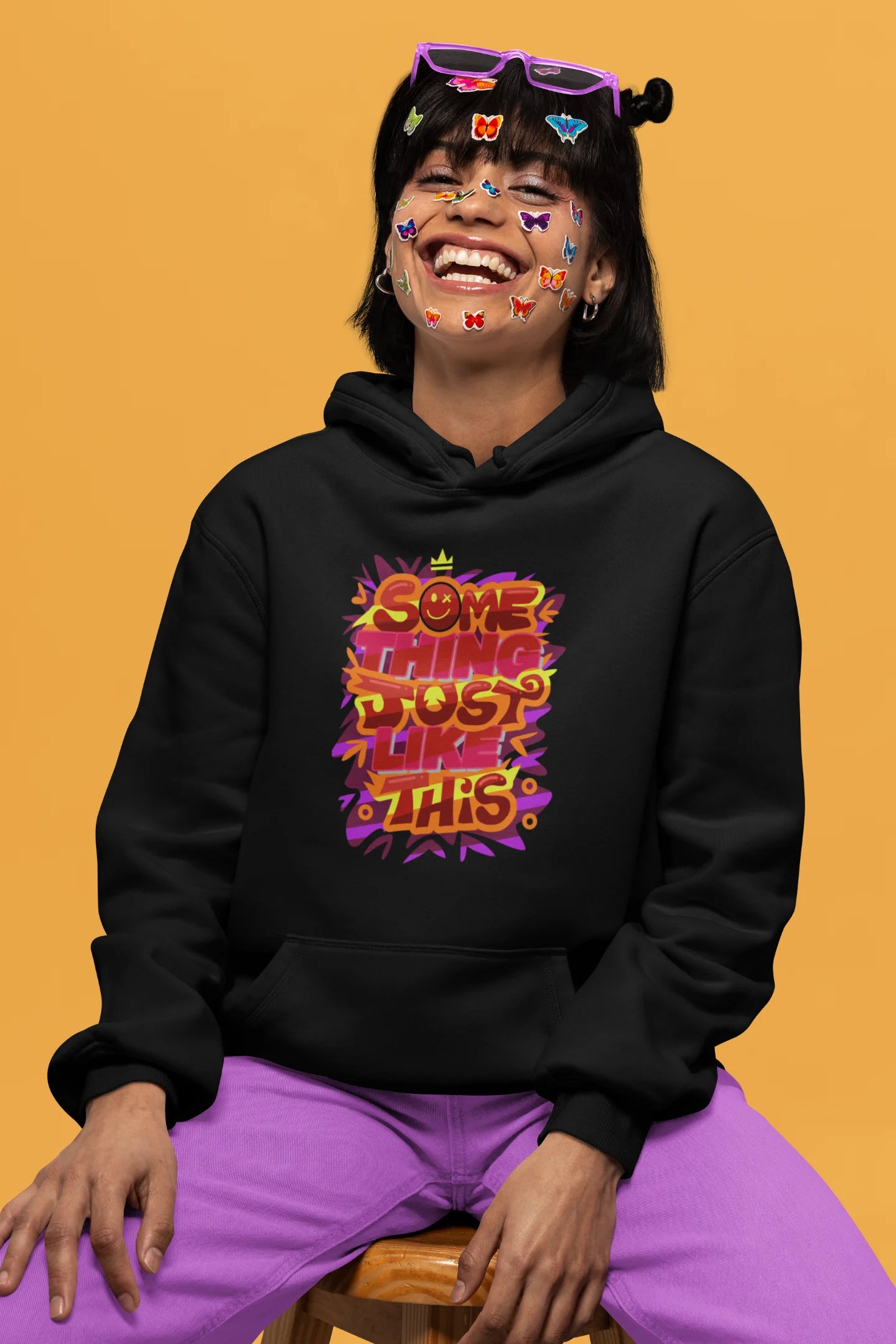 Fifth front view of a female model wearing an black hoodie featuring the designs inspired from Coldplay's "Something Just Like This" music video.