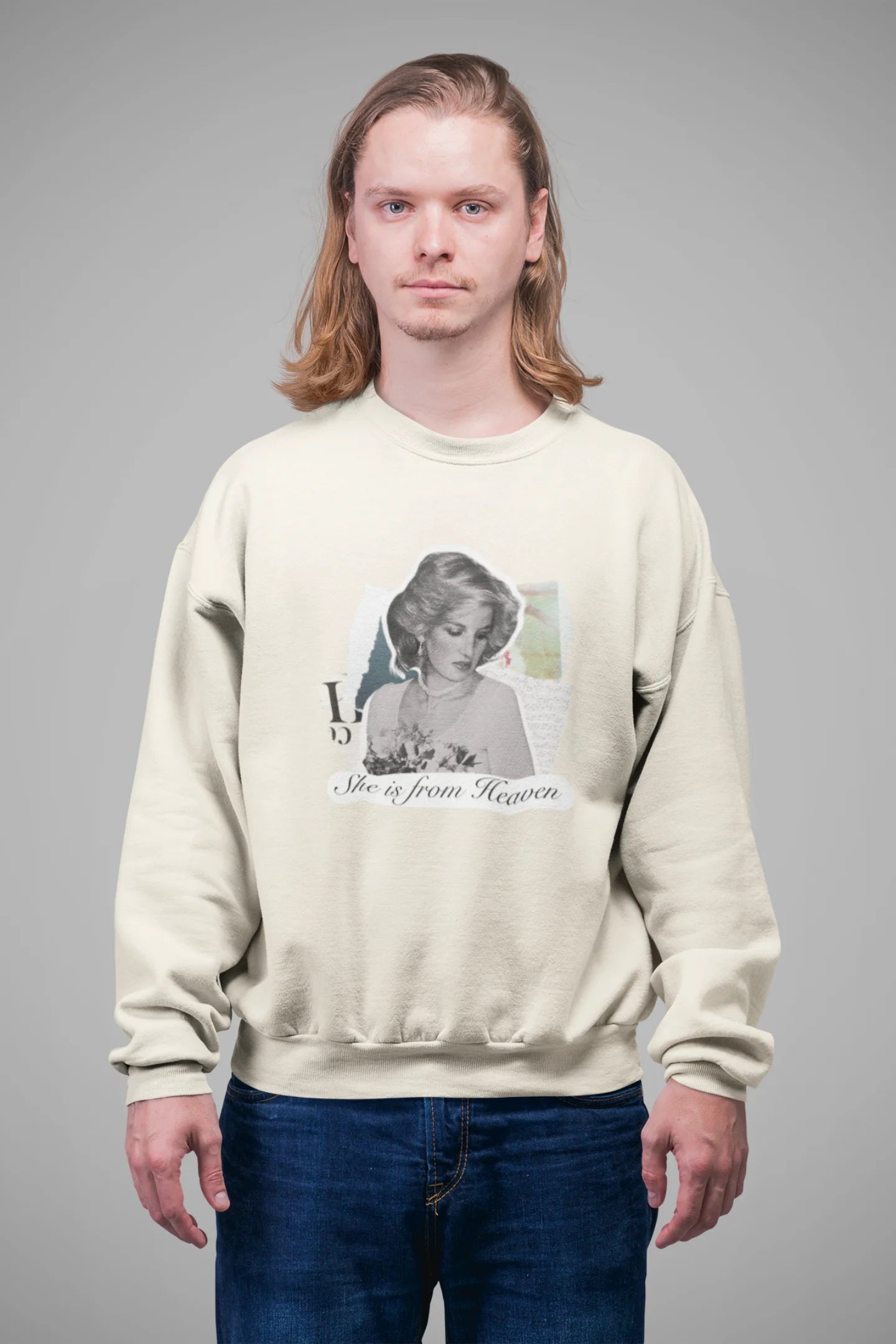 First front view of male model wearing a cream sweatshirt featuring a black and white photo of Princess Diana with the text "She is from Heaven." Ideal for fans of Princess Diana and those who want to celebrate a royal icon.