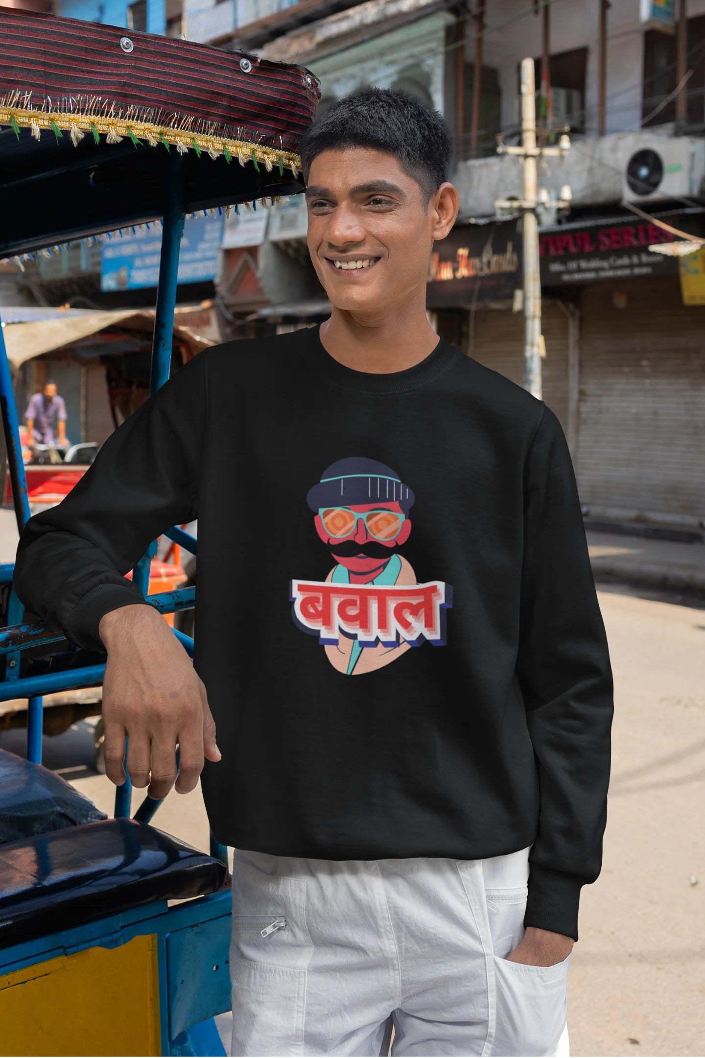 4th front view of a male model wearing a black oversized t-shirt with "Bawaal" in a stylish Hindi.