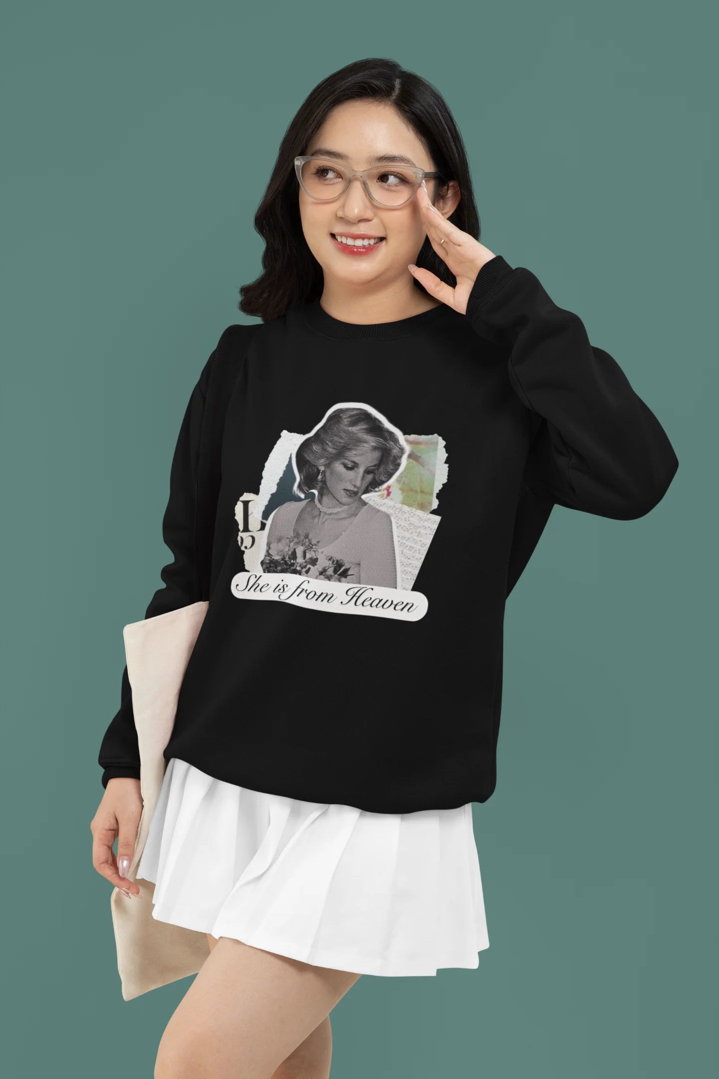 4th front view of female model wearing a black sweatshirt featuring a black and white photo of Princess Diana with the text "She is from Heaven." Ideal for fans of Princess Diana and those who want to celebrate a royal icon.