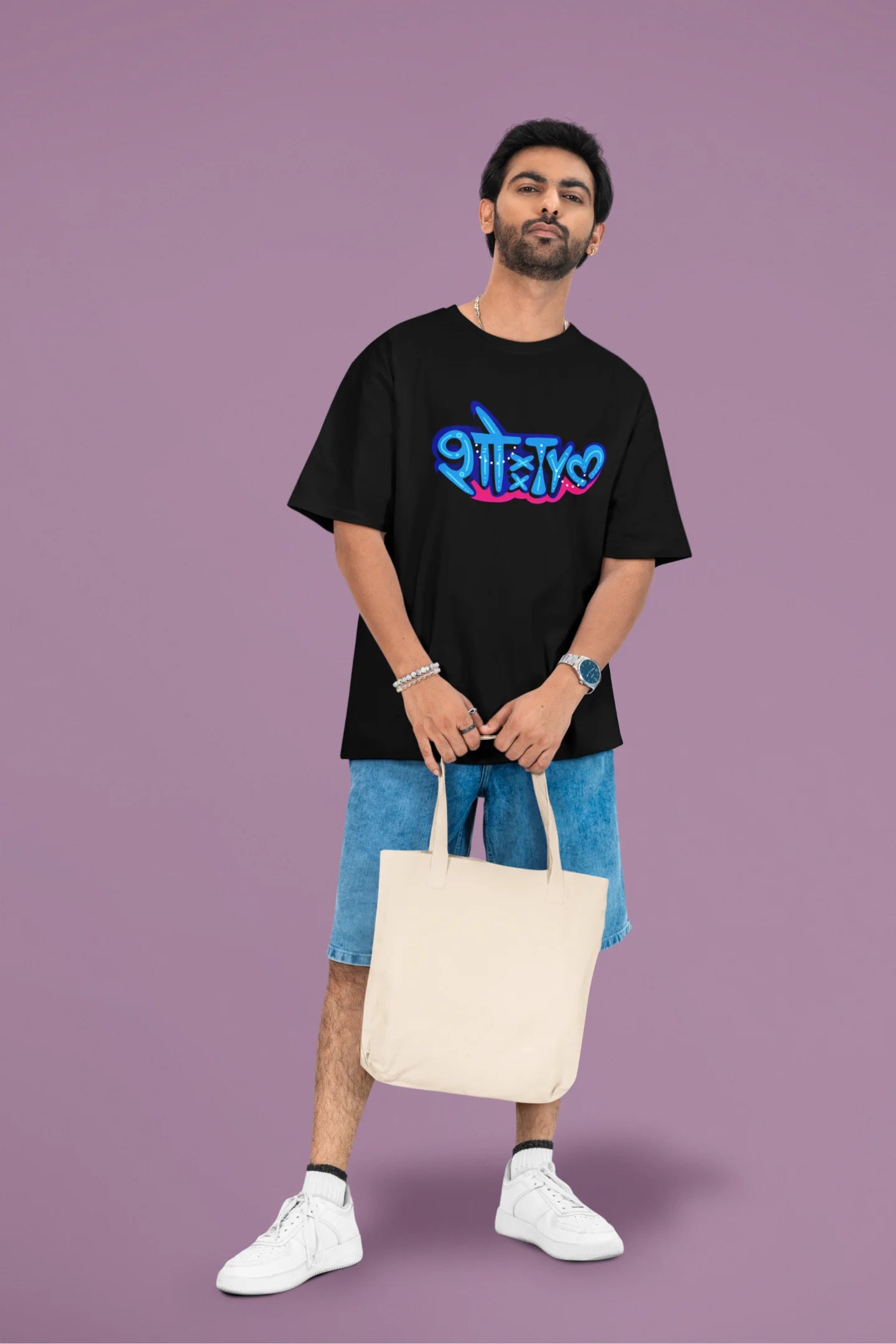 3rd front view of a male model wearing a black oversized t-shirt featuring "Showtime" in Hindi.