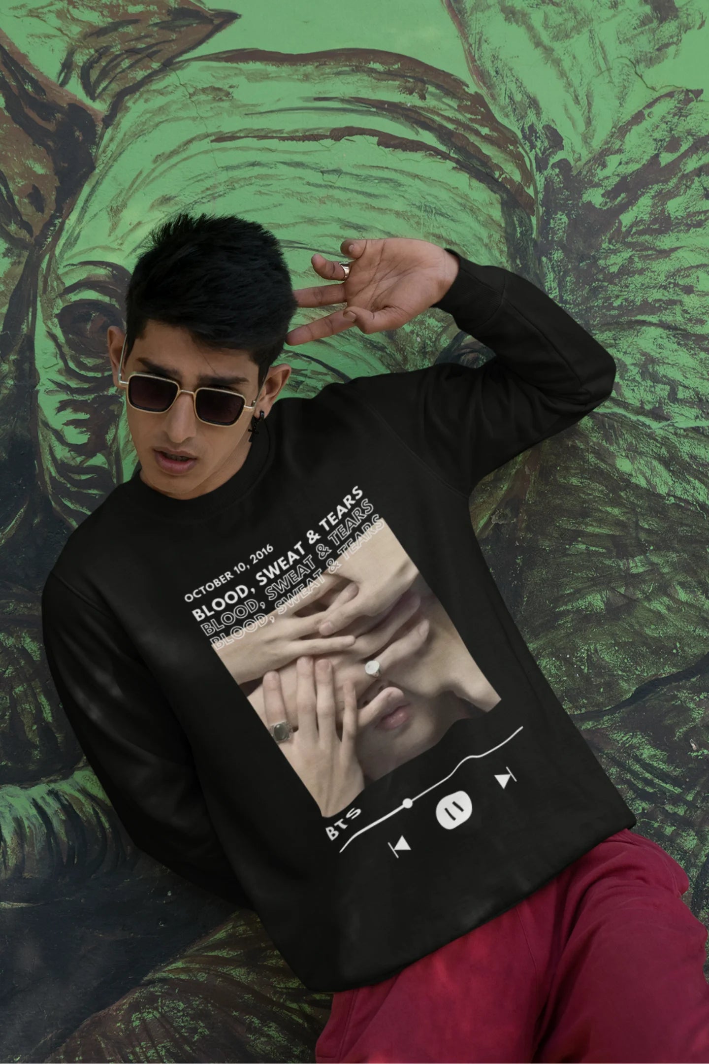 Third front view of a male model wearing a black sweatshirt featuring a design inspired by BTS's music video "Blood, Sweat & Tears." Ideal for BTS fans (ARMY) who want to celebrate this iconic era.