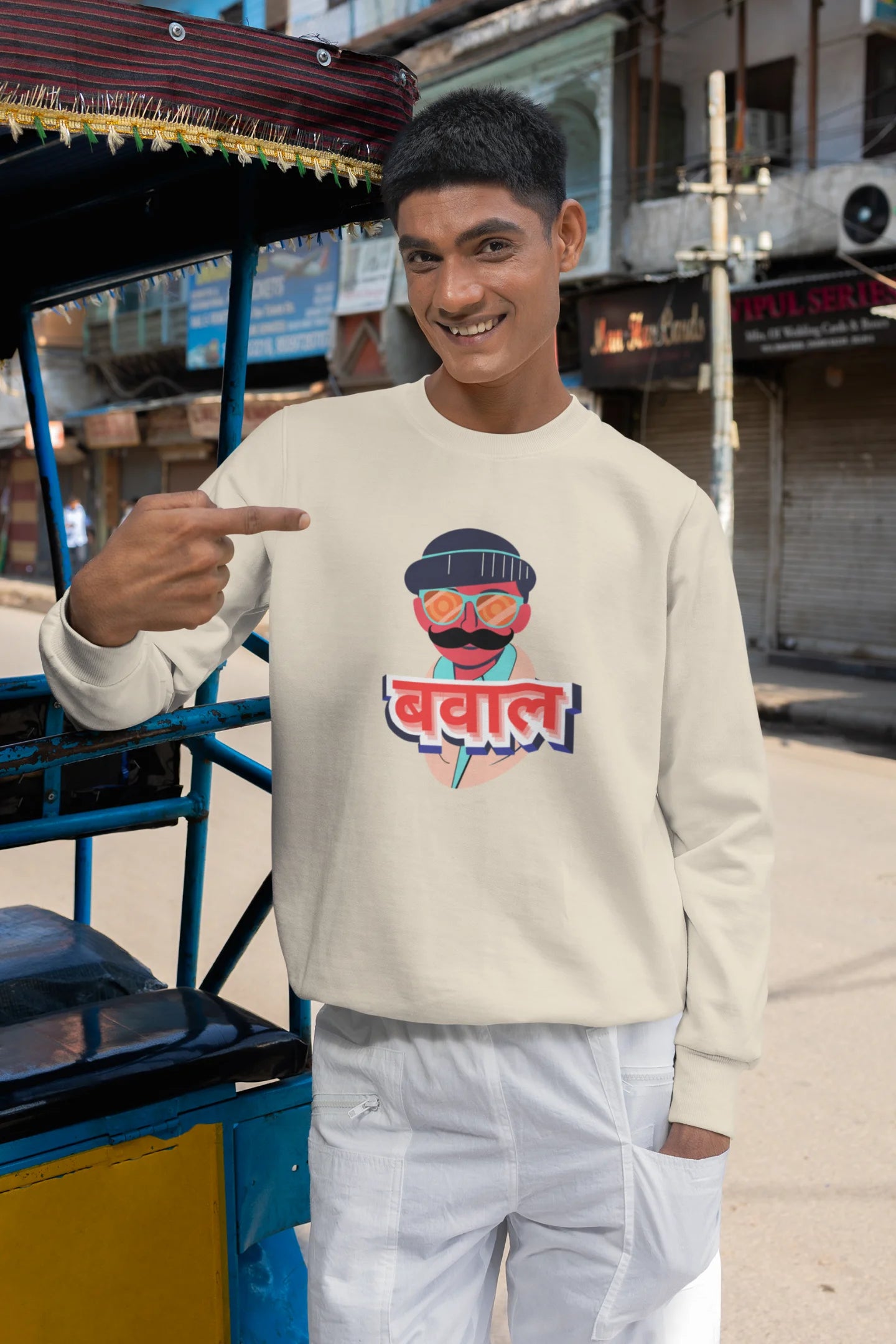 5th front view of a male model wearing a cream oversized t-shirt with "Bawaal" in a stylish Hindi.