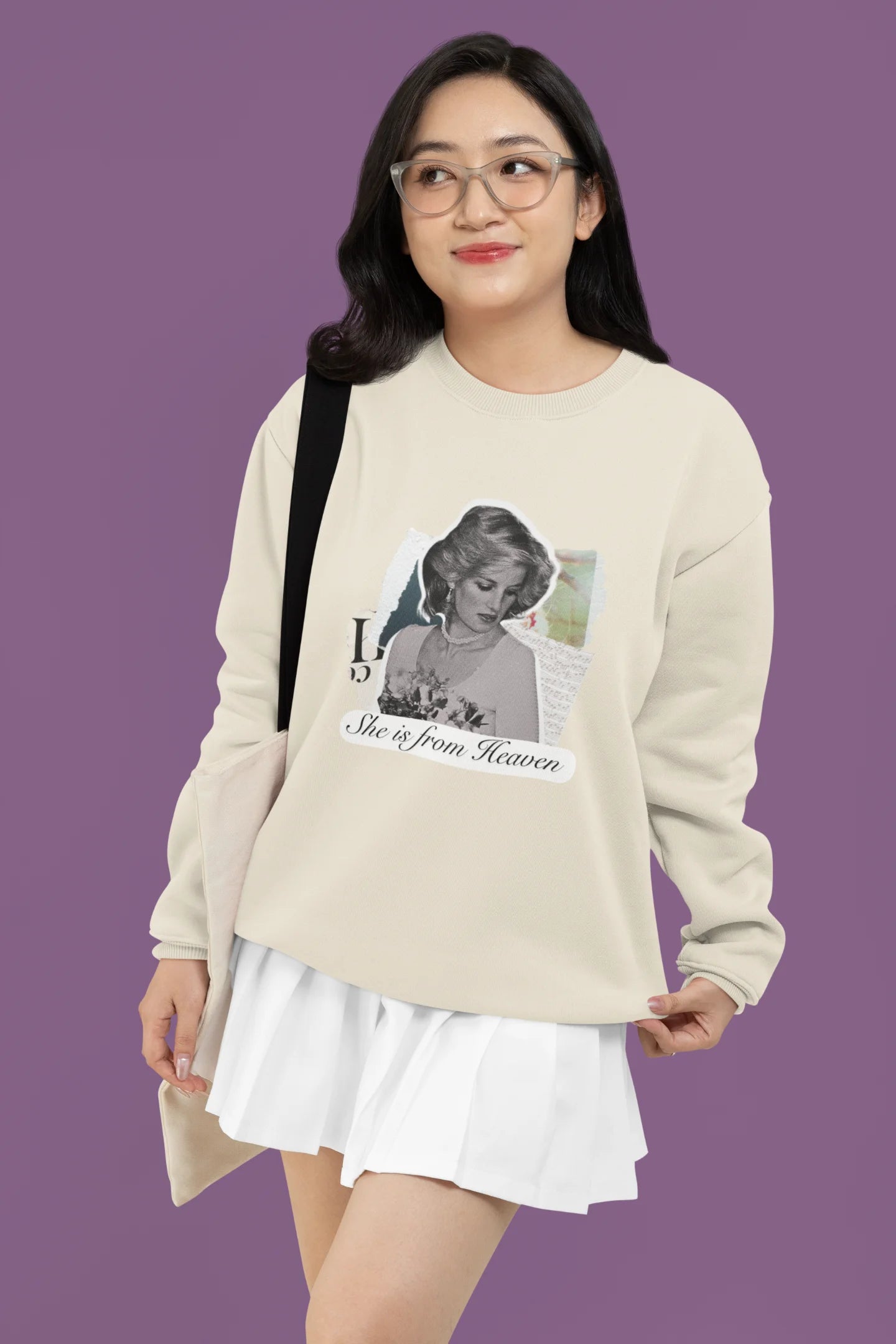 4th front view of female model wearing a cream sweatshirt featuring a black and white photo of Princess Diana with the text "She is from Heaven." Ideal for fans of Princess Diana and those who want to celebrate a royal icon.