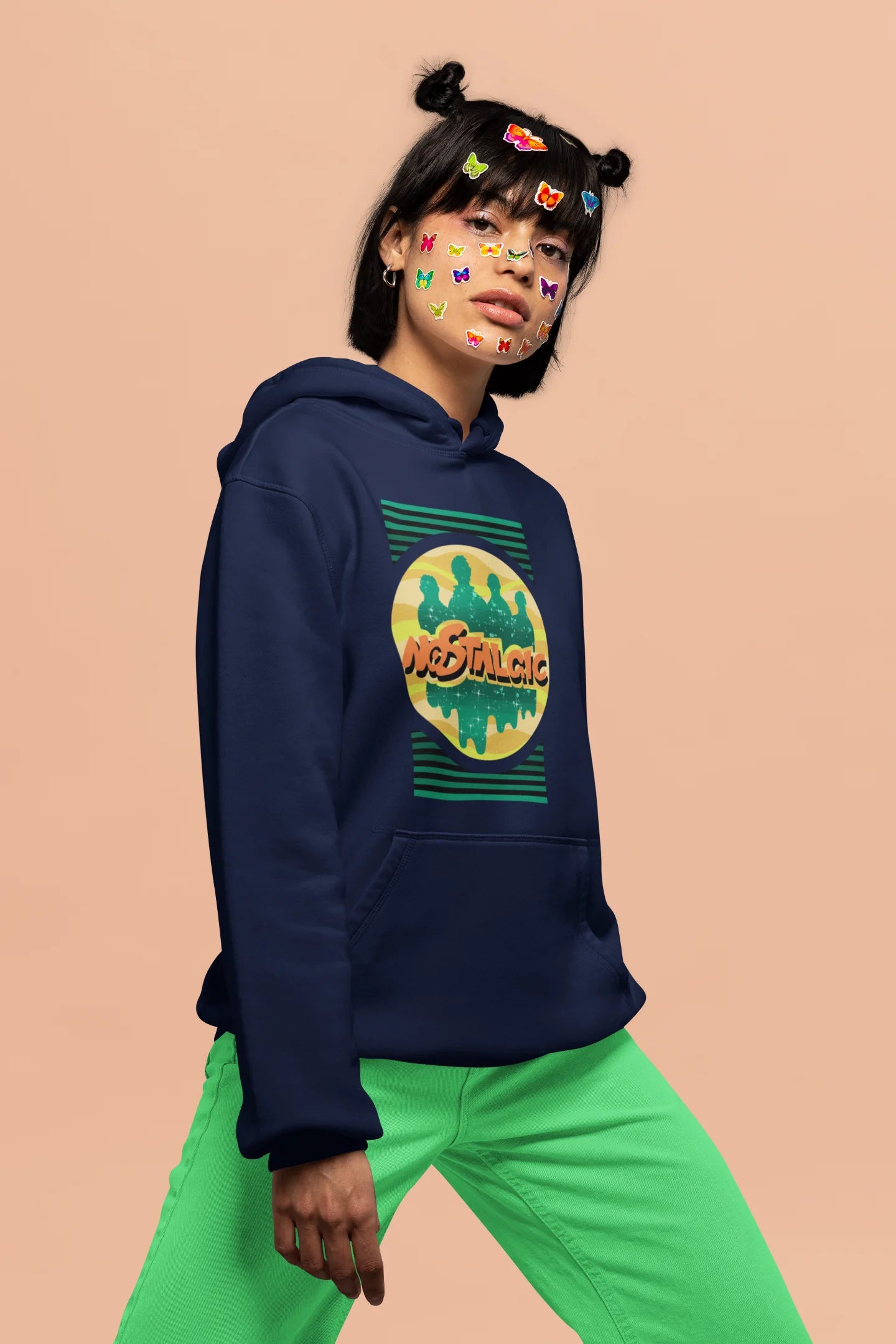 5th front view of a female model wearing an navy blue hoodie with a shadow silhouette of the Coldplay band members and the word "Nostalgic" printed on it.