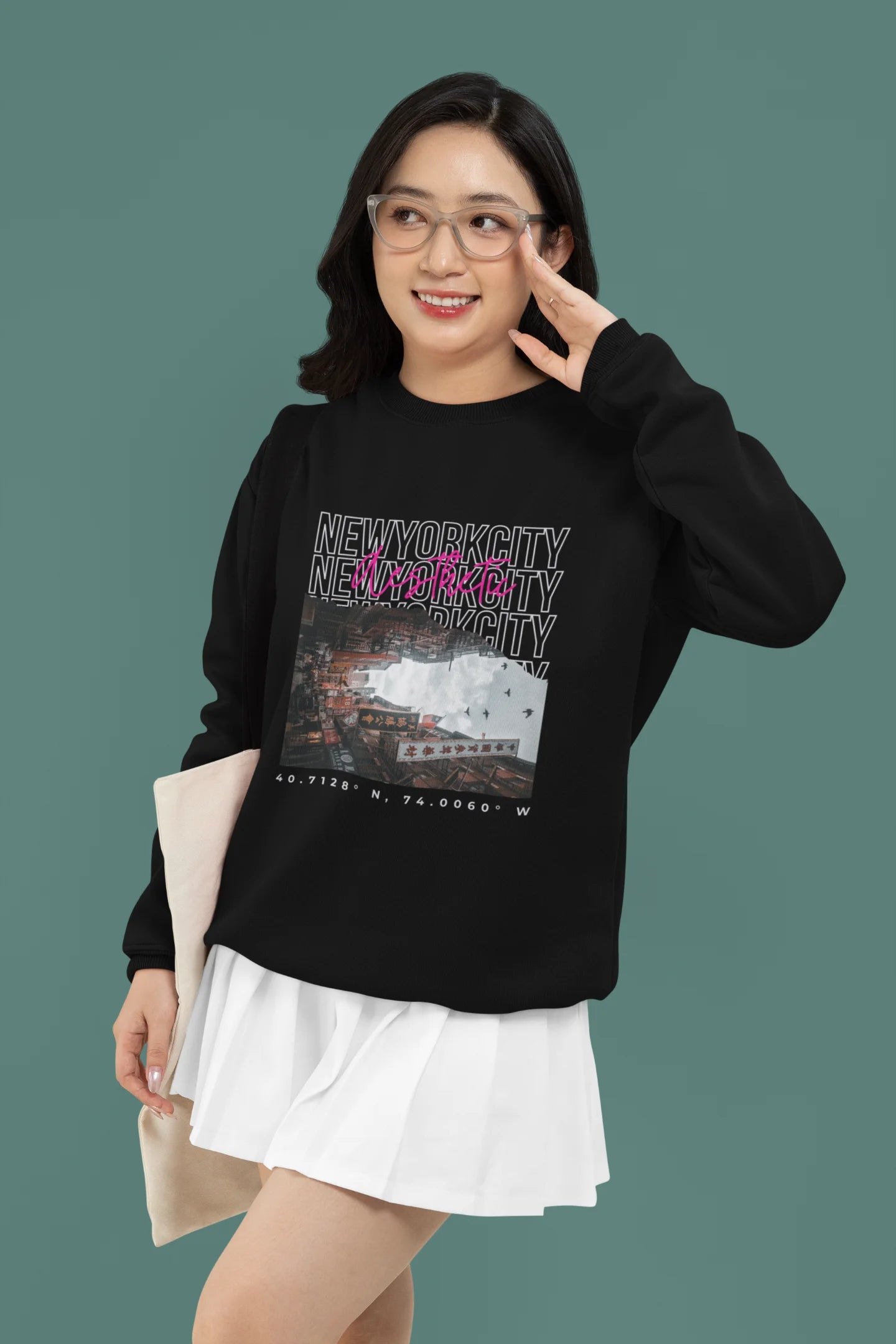 First front view of a female model wearing a black sweatshirt with a New York City skyline design, offering a relaxed urban aesthetic.